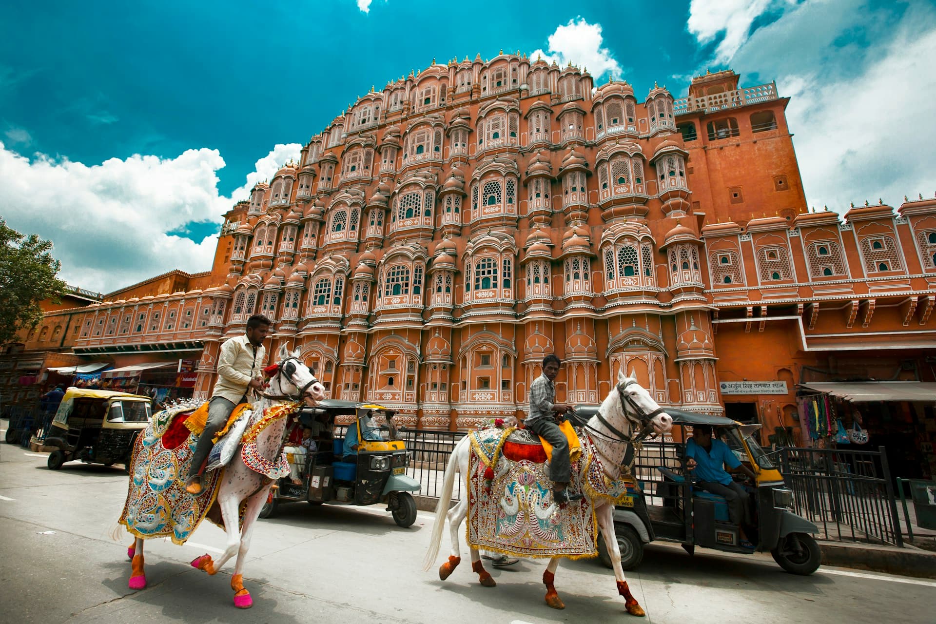 Horse carriages passing the Hawa Mahal in Jaipur