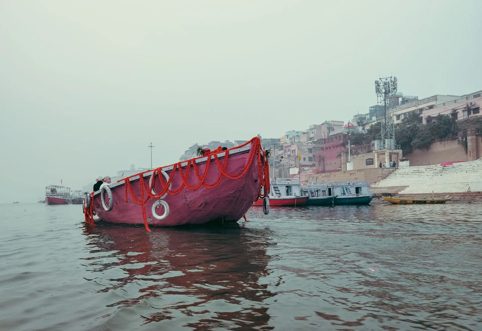 Colorful boats and historic ghats along the Ganges River in Varanasi, India