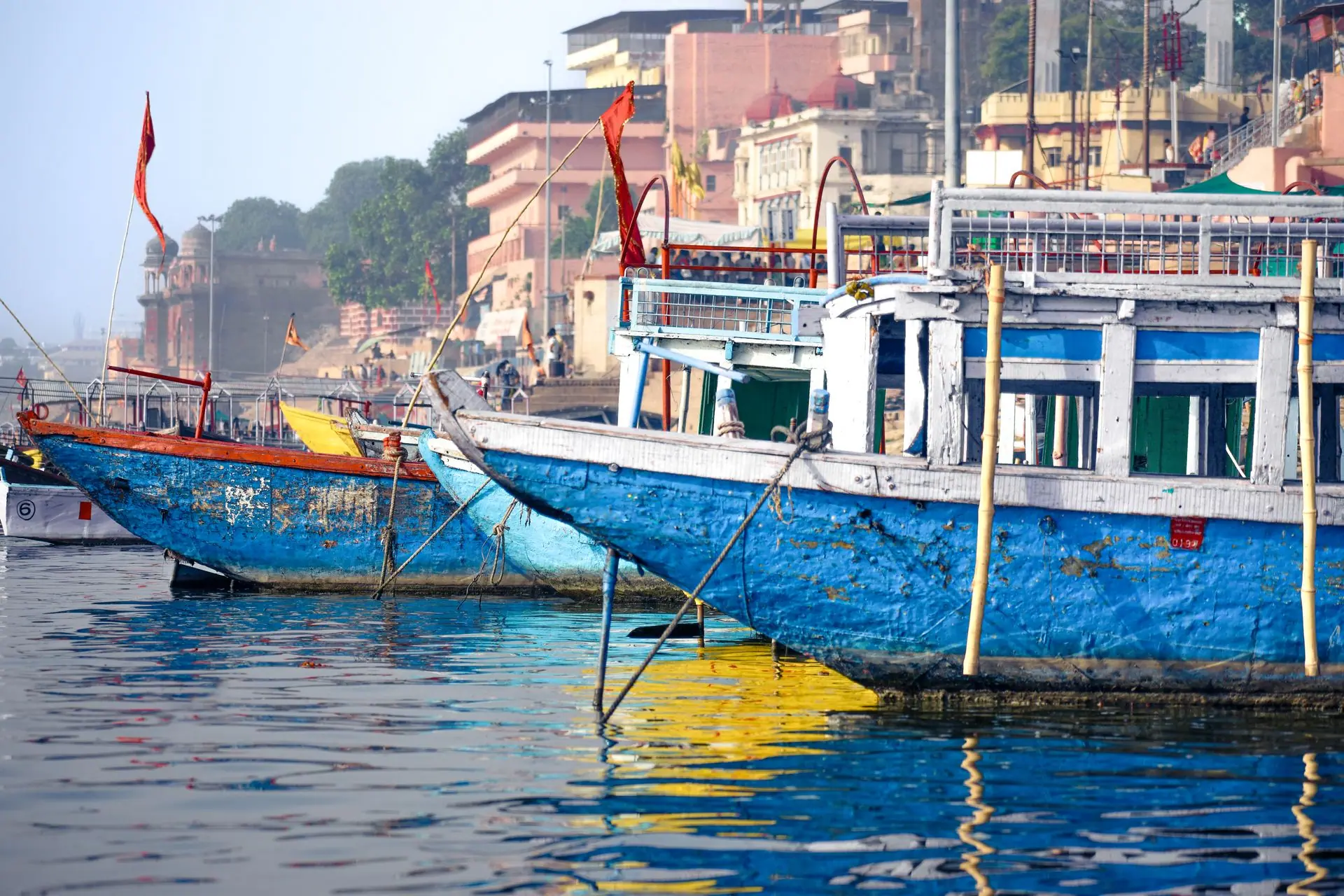 Vibrant boats moored along the Varanasi riverbanks reflect cultural heritage