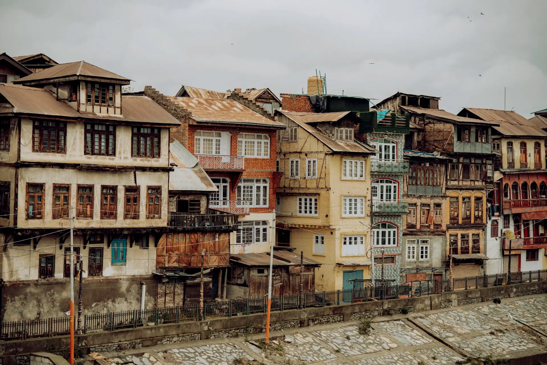 Charming old houses along Jhelum River in Srinagar, showcasing traditional architecture