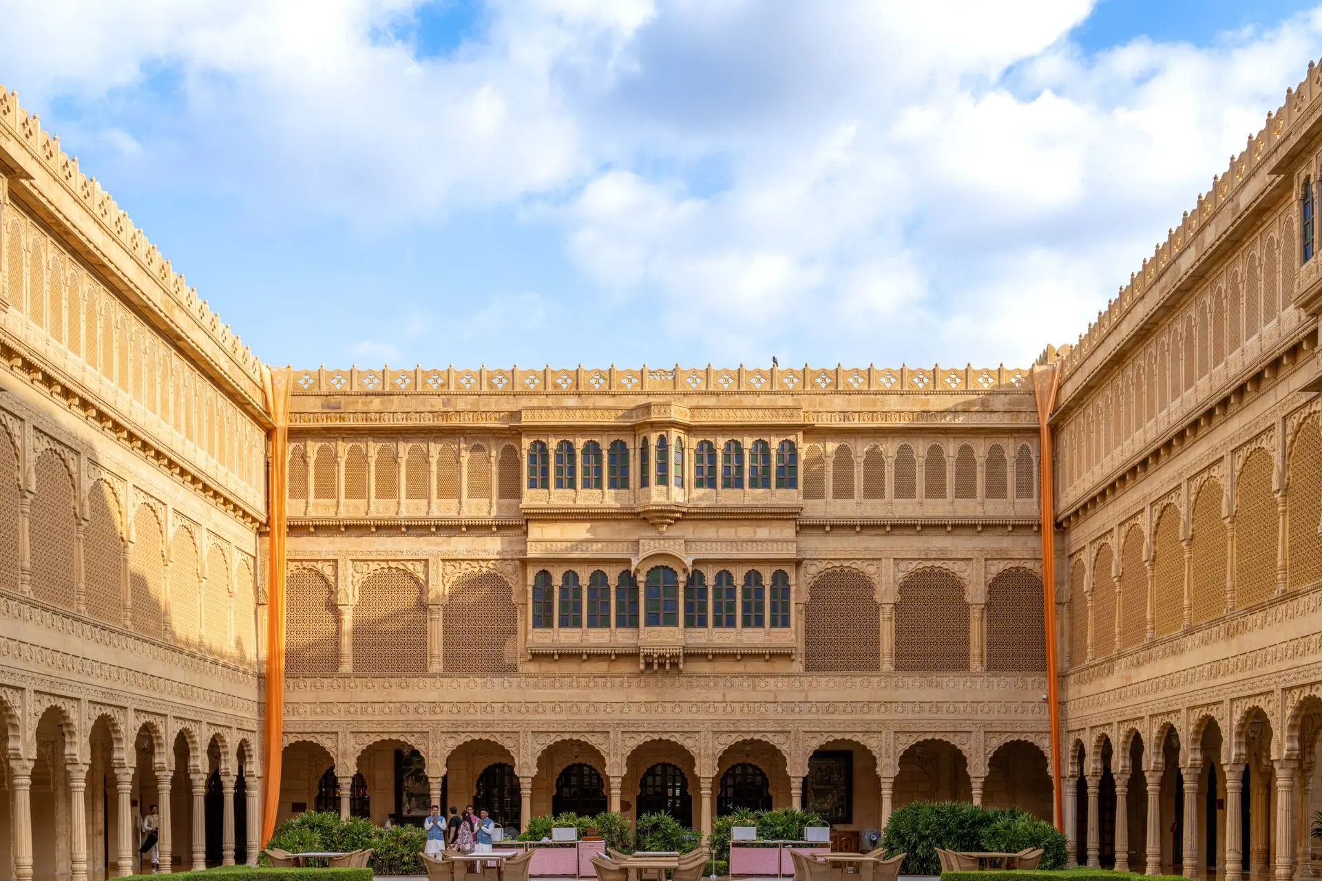 Exquisite courtyard of a heritage hotel in Jaisalmer, showcasing traditional Rajasthani architecture and ornate sandstone carvings