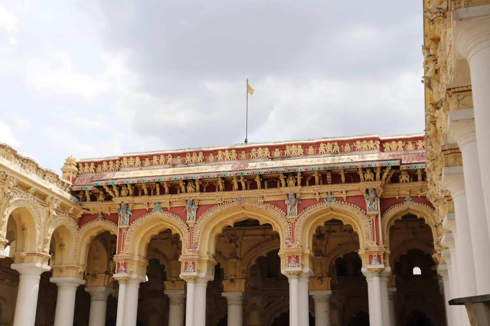 Explore the ornate arches and sculptures of Thirumalai Nayakkar Mahal in Madurai, showcasing Indo-Saracenic architecture