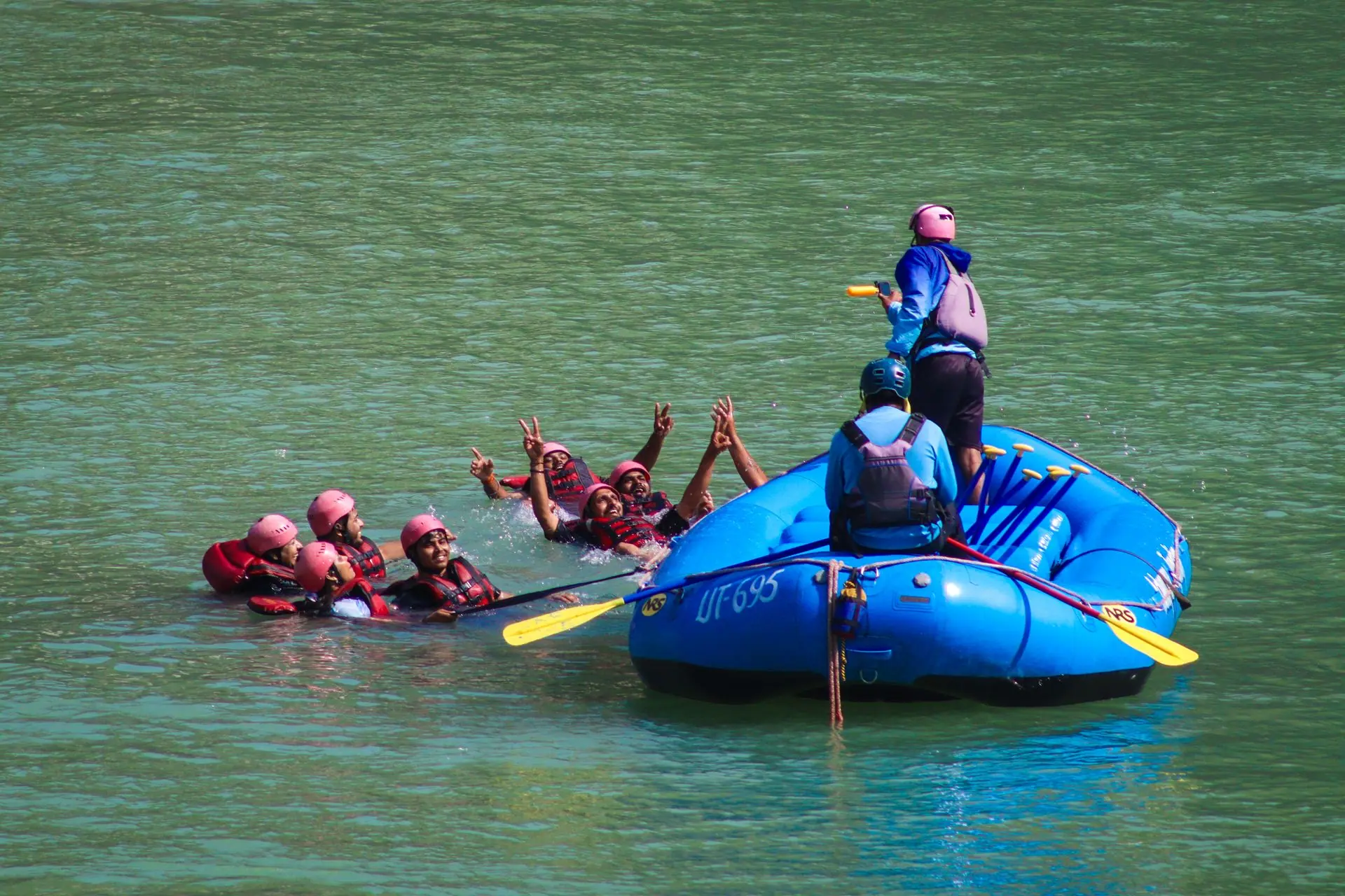Group rafting experience in Rishikesh with people enjoying the river. Perfect for adventure lovers