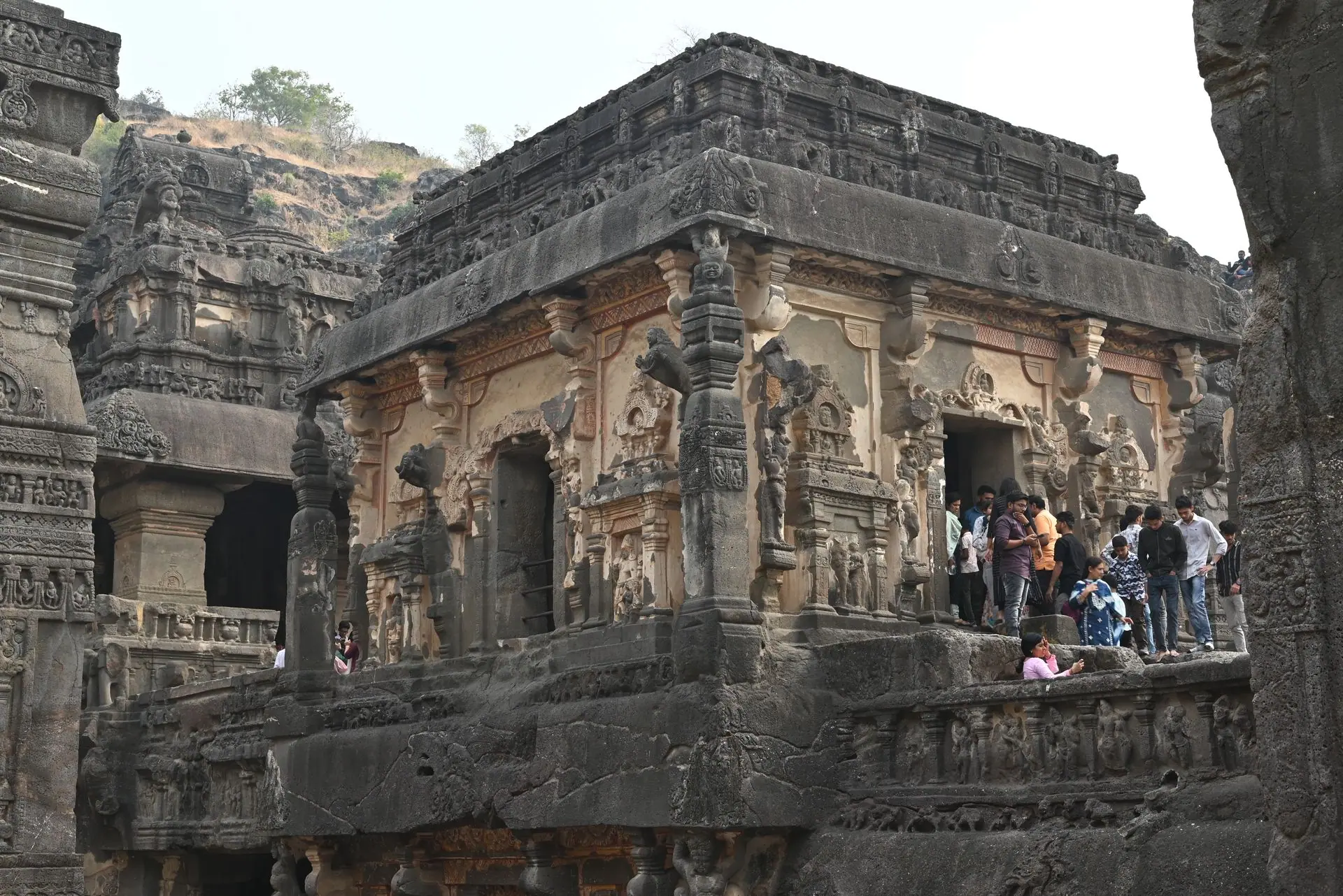 Explore the stunning rock-cut architecture of Ellora Caves featuring intricate carvings and vibrant history