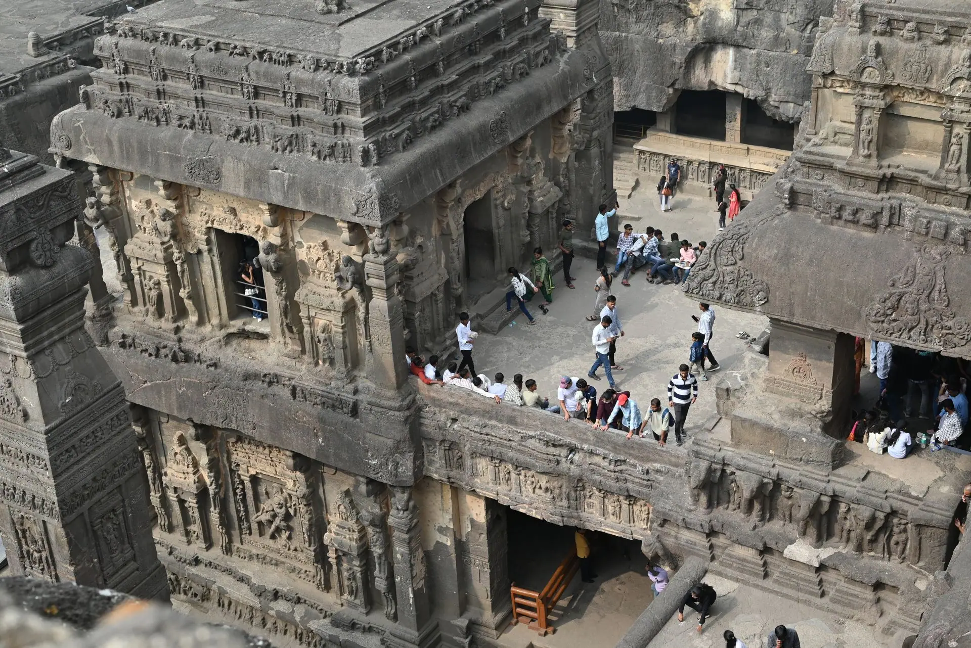 Aerial view of the ancient Kailasa Temple at Ellora Caves, bustling with tourists