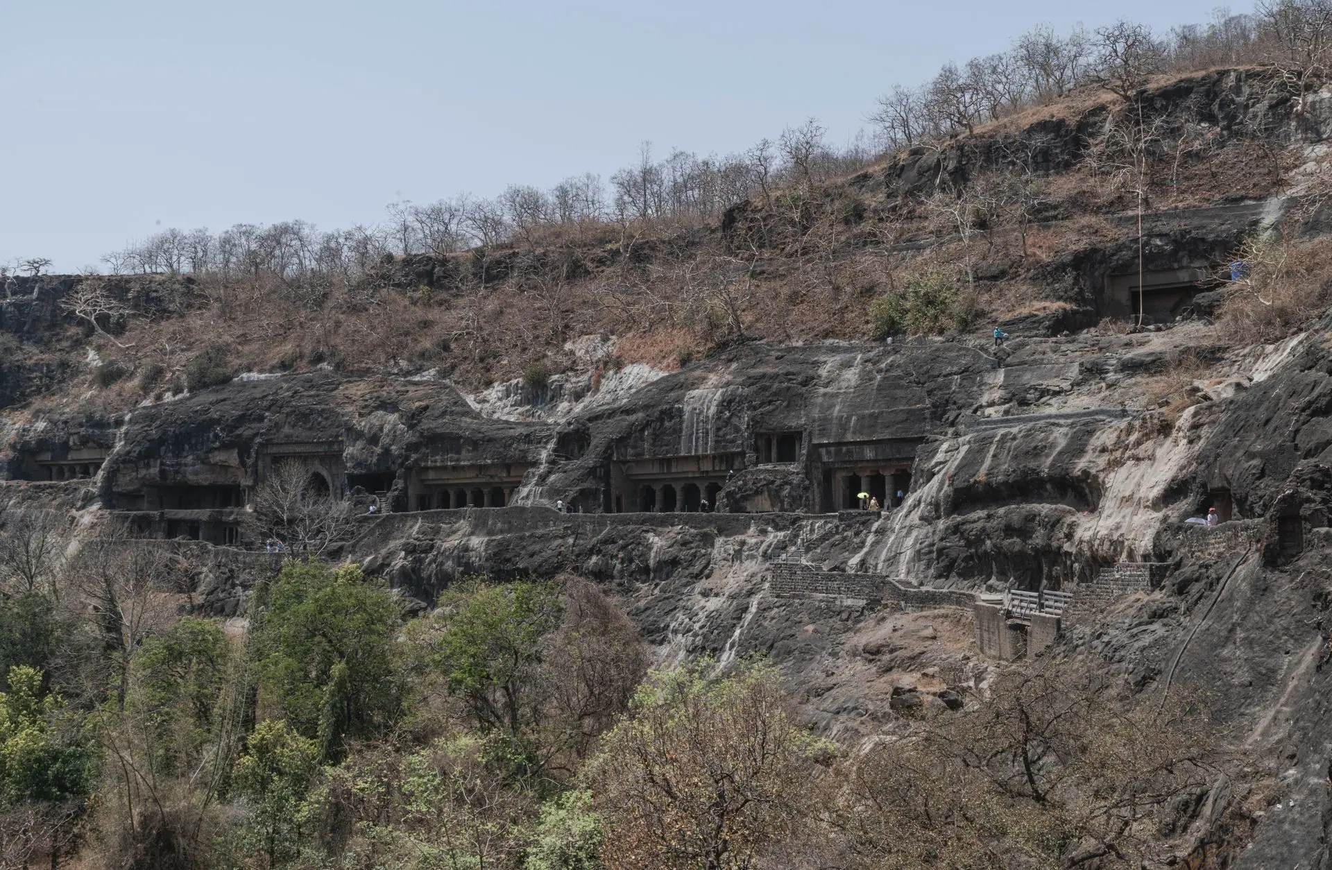 Explore the ancient rock-cut Ajanta Caves nestled in Maharashtra's rugged terrain