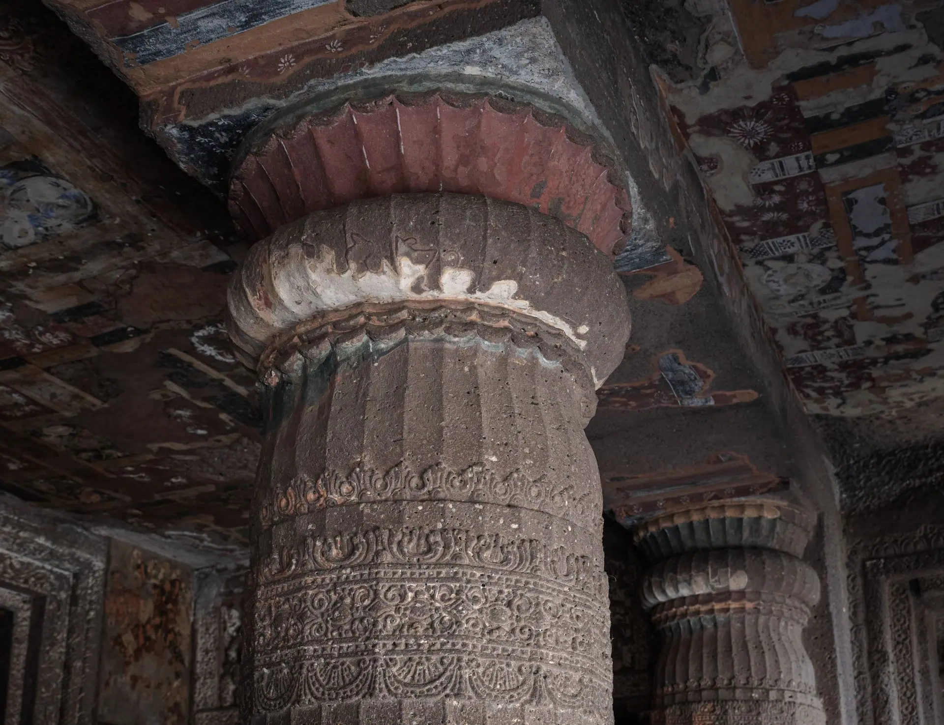 Detailed stone column in the Ajanta Caves showcasing ancient Indian rock-cut architecture