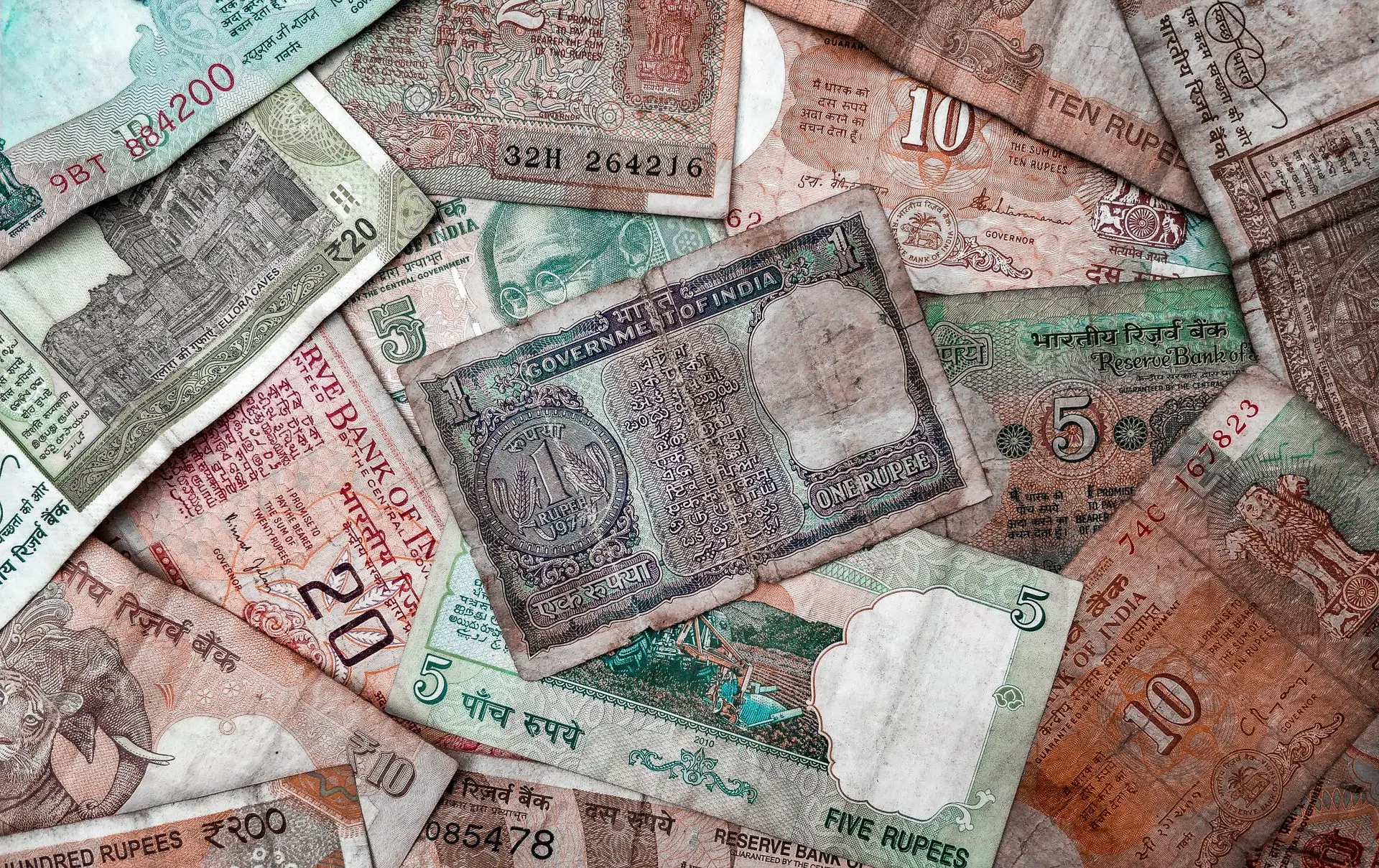 A collection of diverse vintage Indian rupee notes showcasing various denominations and designs