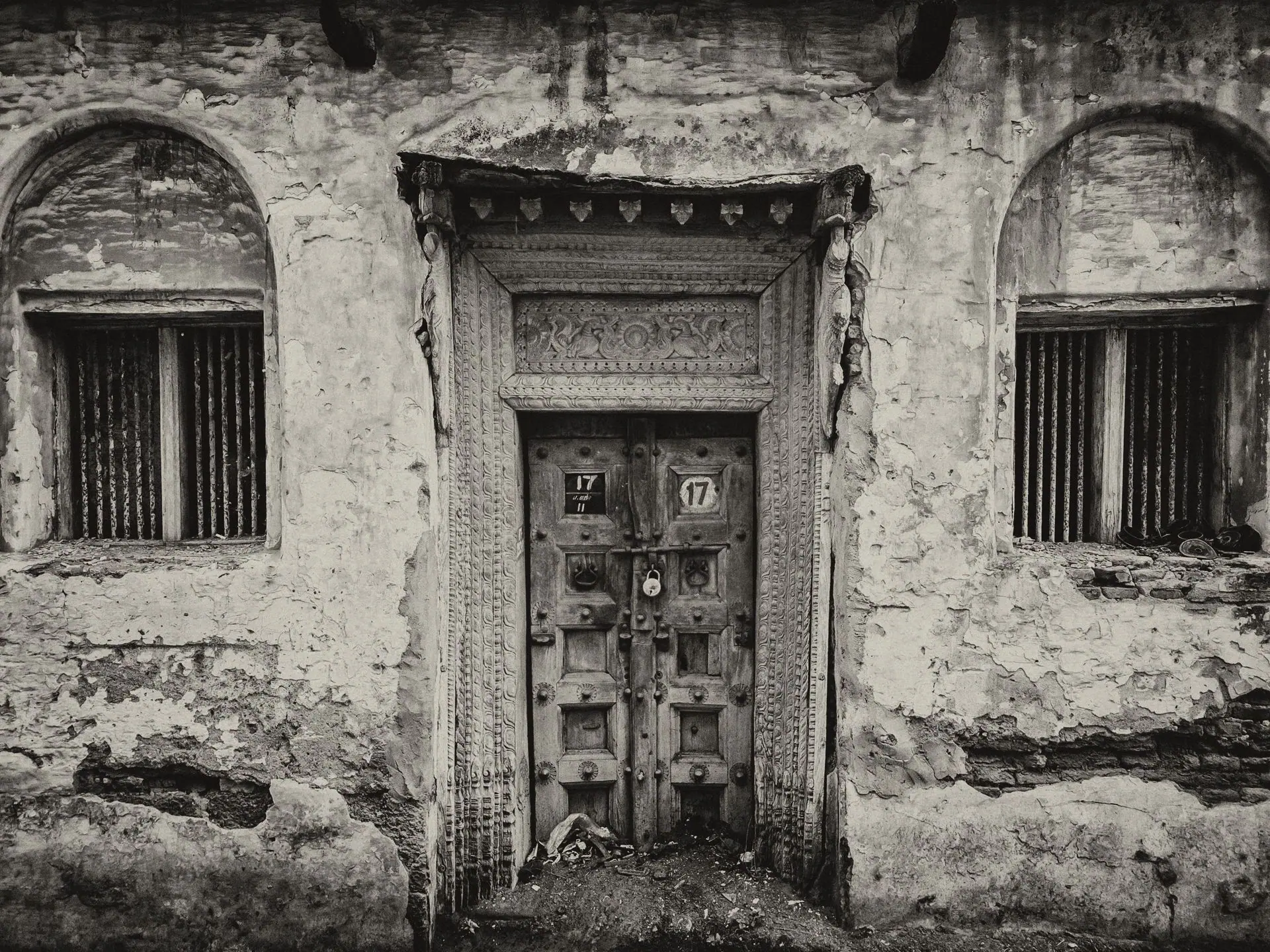Rustic abandoned doorway of a Chettinadu house in monochrome, showcasing heritage architecture