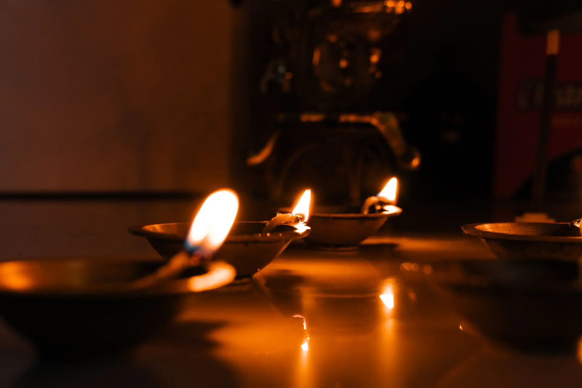 Close-up of traditional diyas lit for Diwali celebration in India, showcasing cultural heritage and warm ambiance