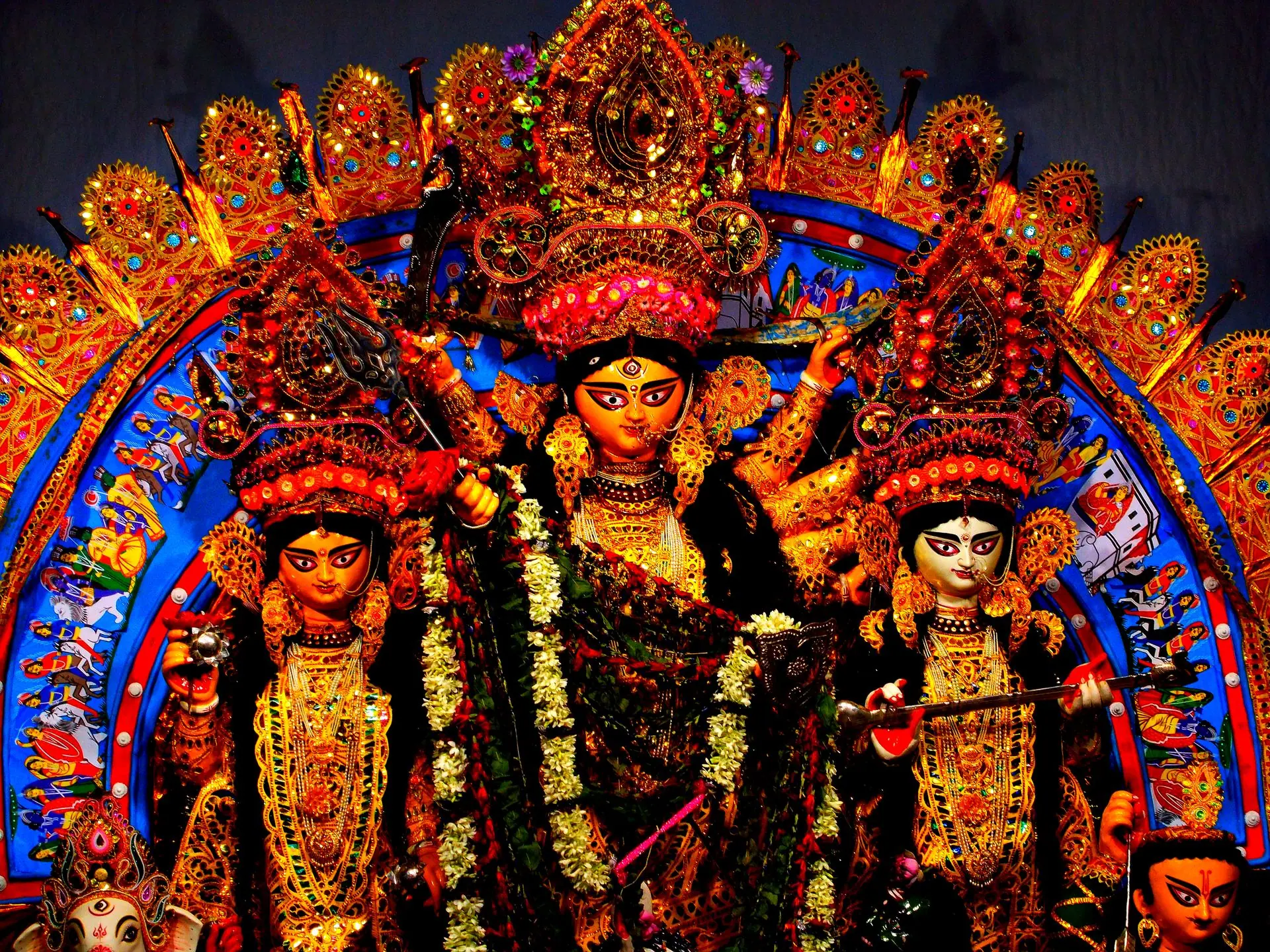 Vibrant Durga Puja sculpture adorned with colorful decorations showcasing Hindu religious artistry
