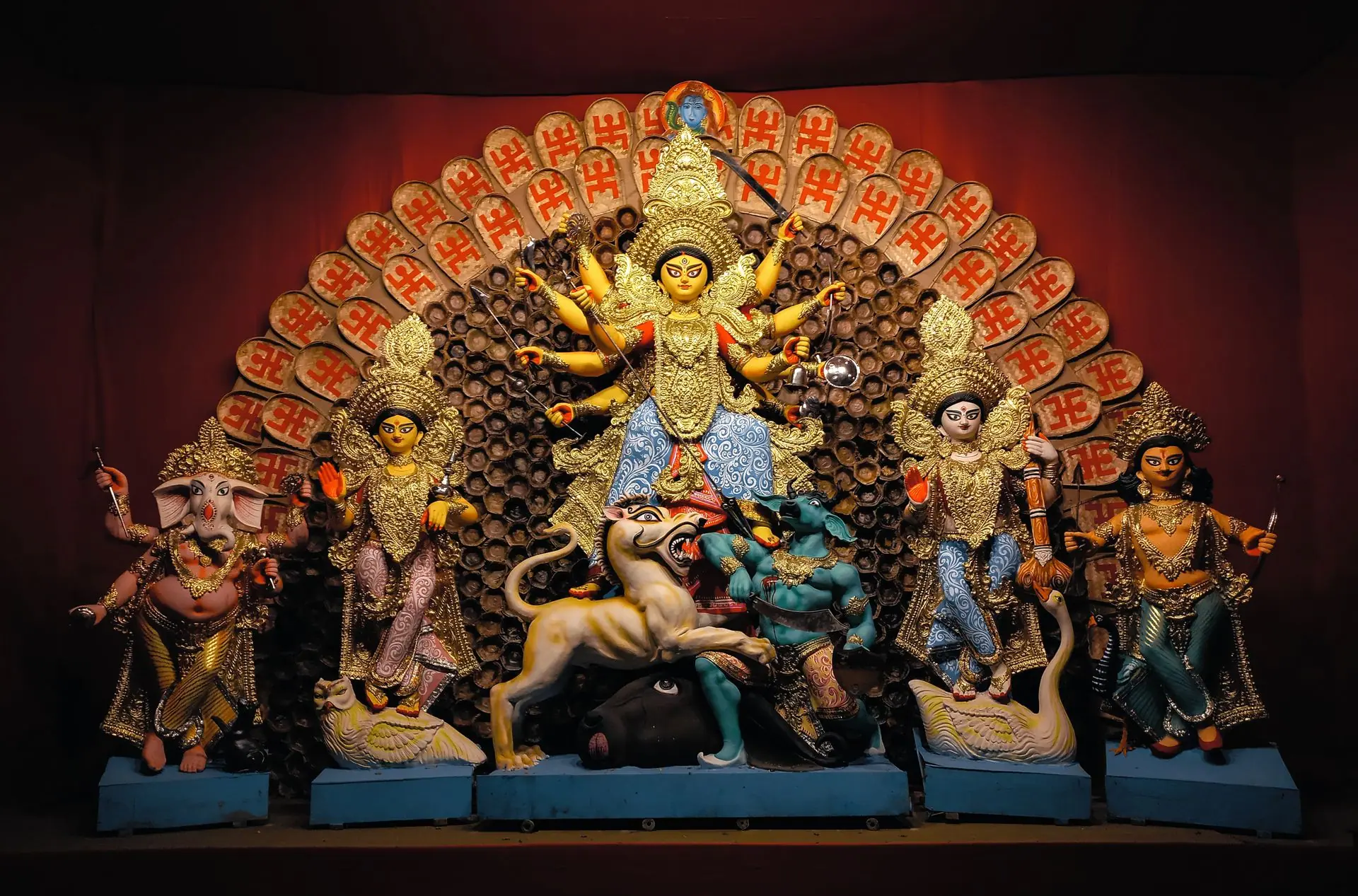 Intricately decorated Hindu deities at a Durga Puja altar in Kolkata, India