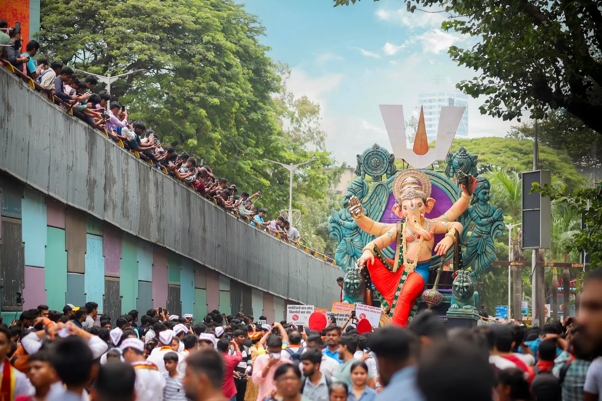 Vibrant Ganesh Chaturthi festival procession with crowds in Mumbai