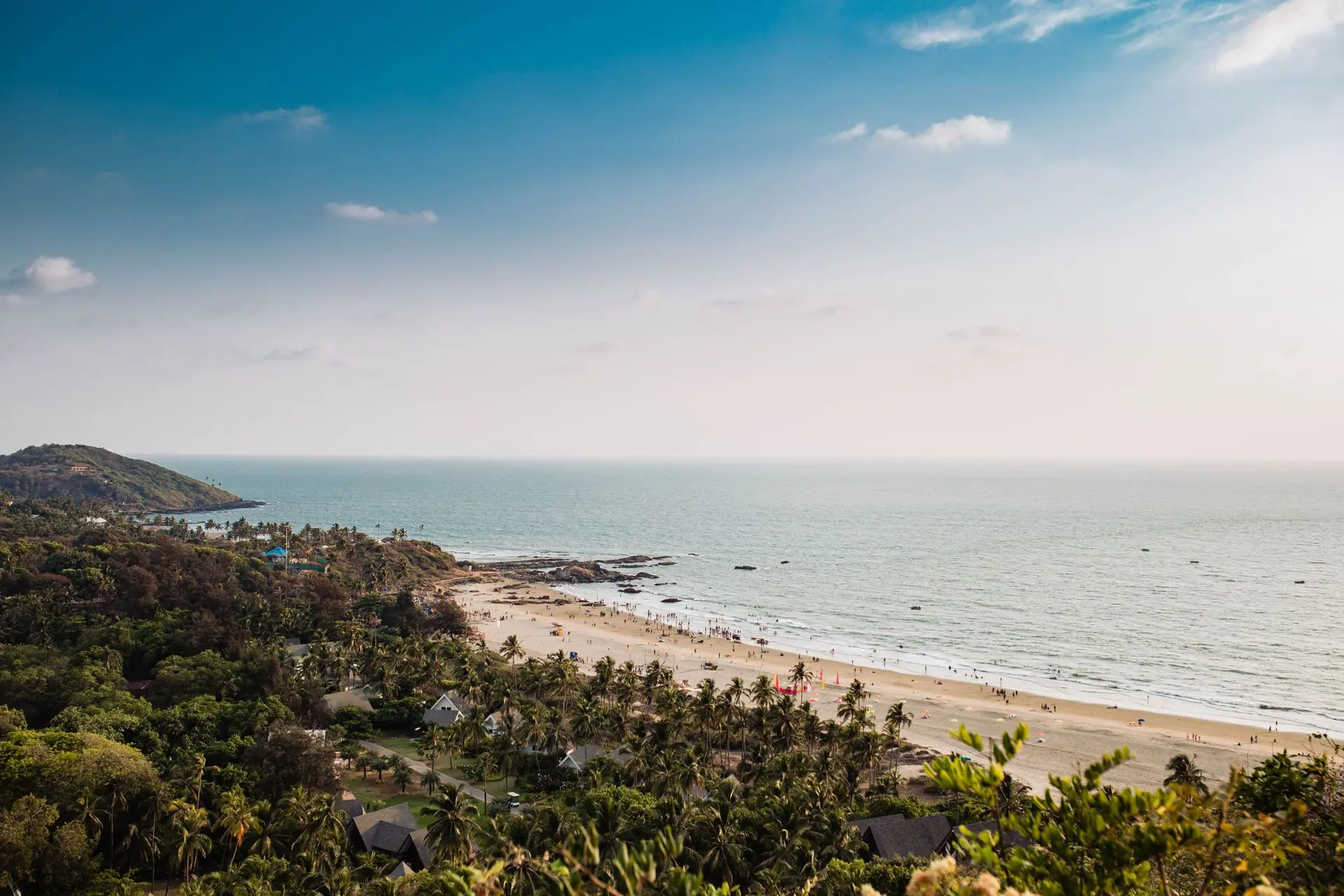 A beautiful aerial view of Mandrem Beach, Goa, with lush greenery and a serene coastline