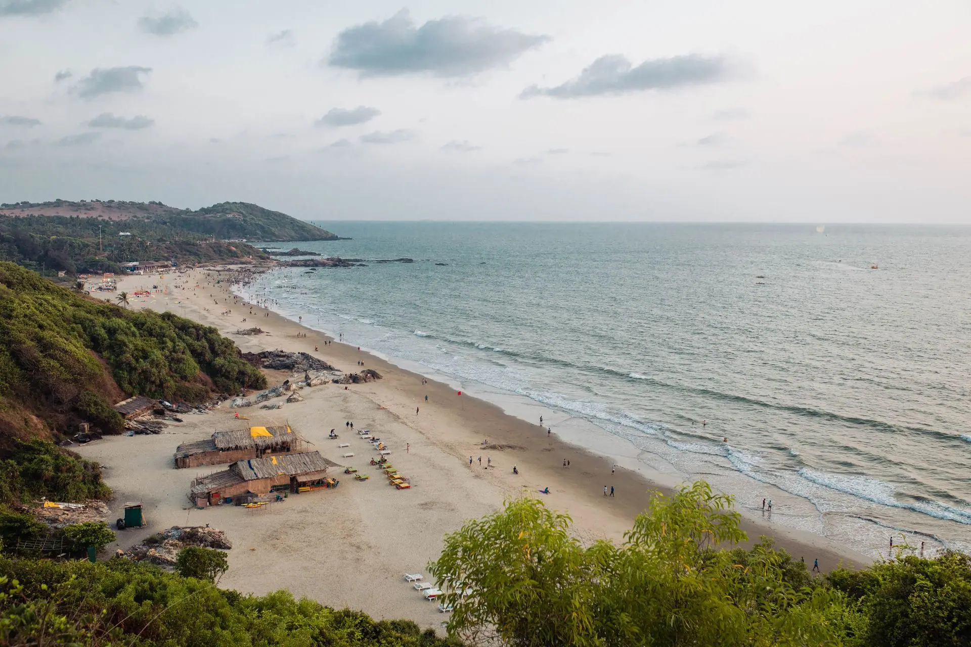 Enjoy the serene aerial view of Chapora Beach, Goa, India, showcasing pristine sands and lush greenery