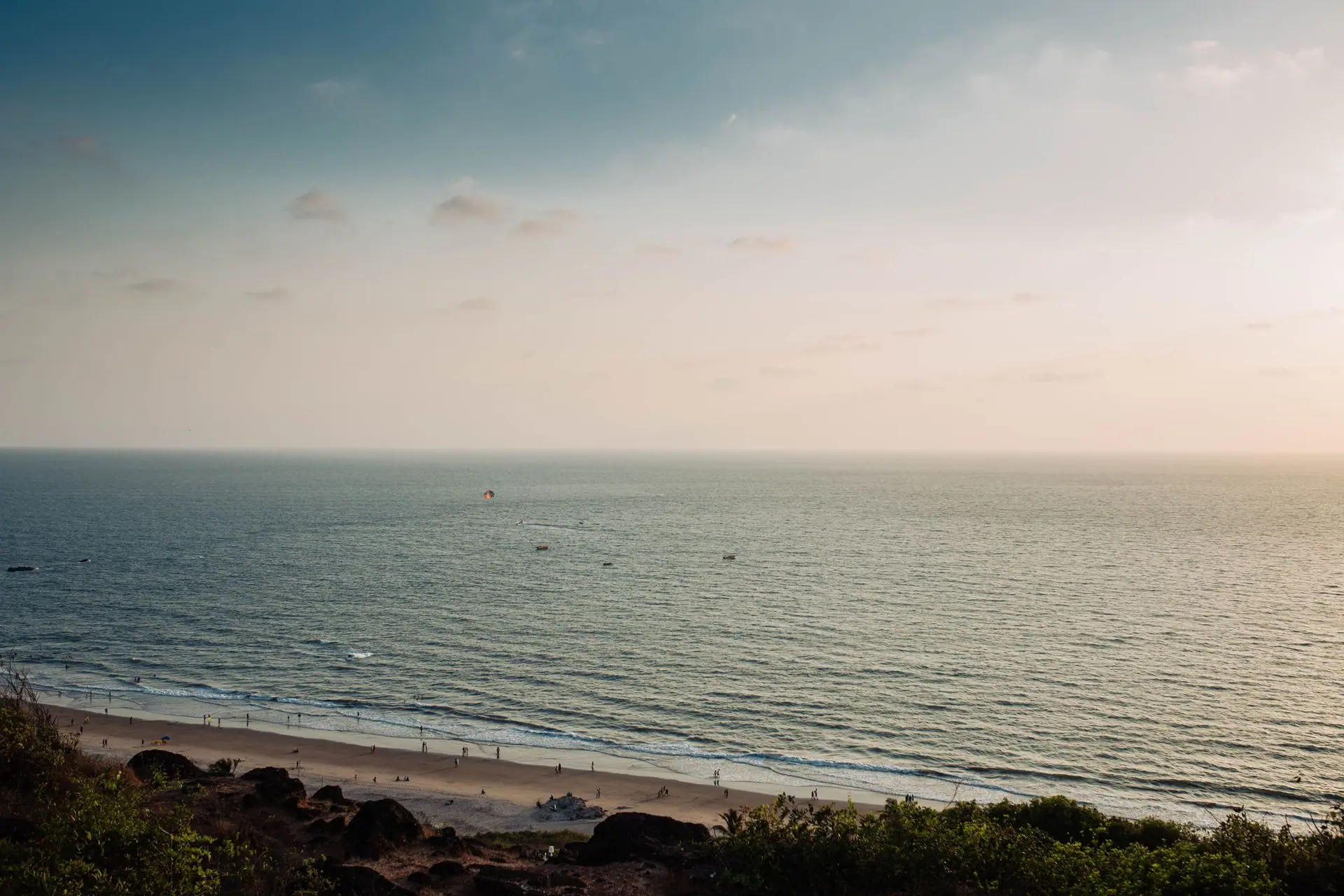 A tranquil view of Chapora Beach in Goa, India captured during sunset with gentle waves and a serene sky