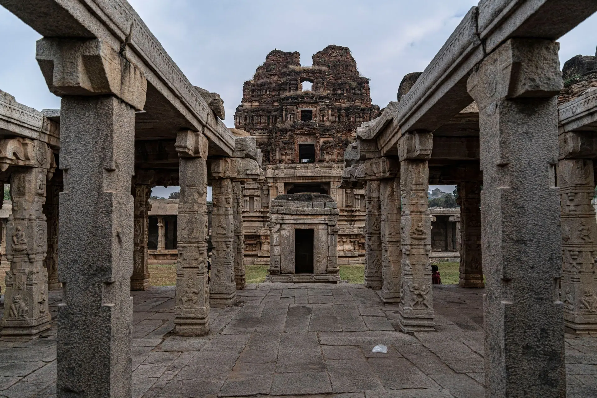 Explore the ancient stone columns and ruins of Hampi, a UNESCO World Heritage Site in India