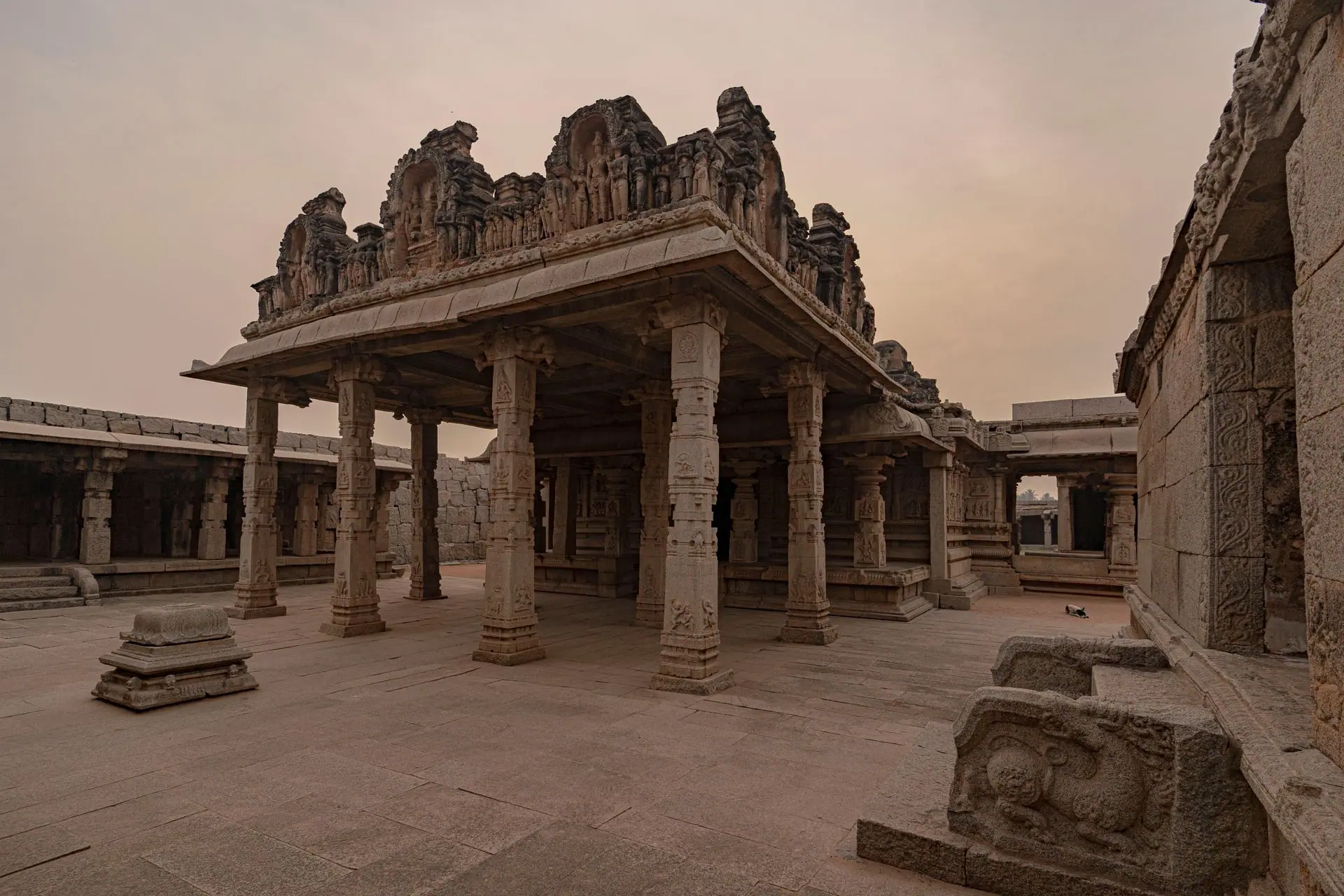 Explore the ancient stone architecture of Hampi, India, showcasing historical columns and intricate carvings