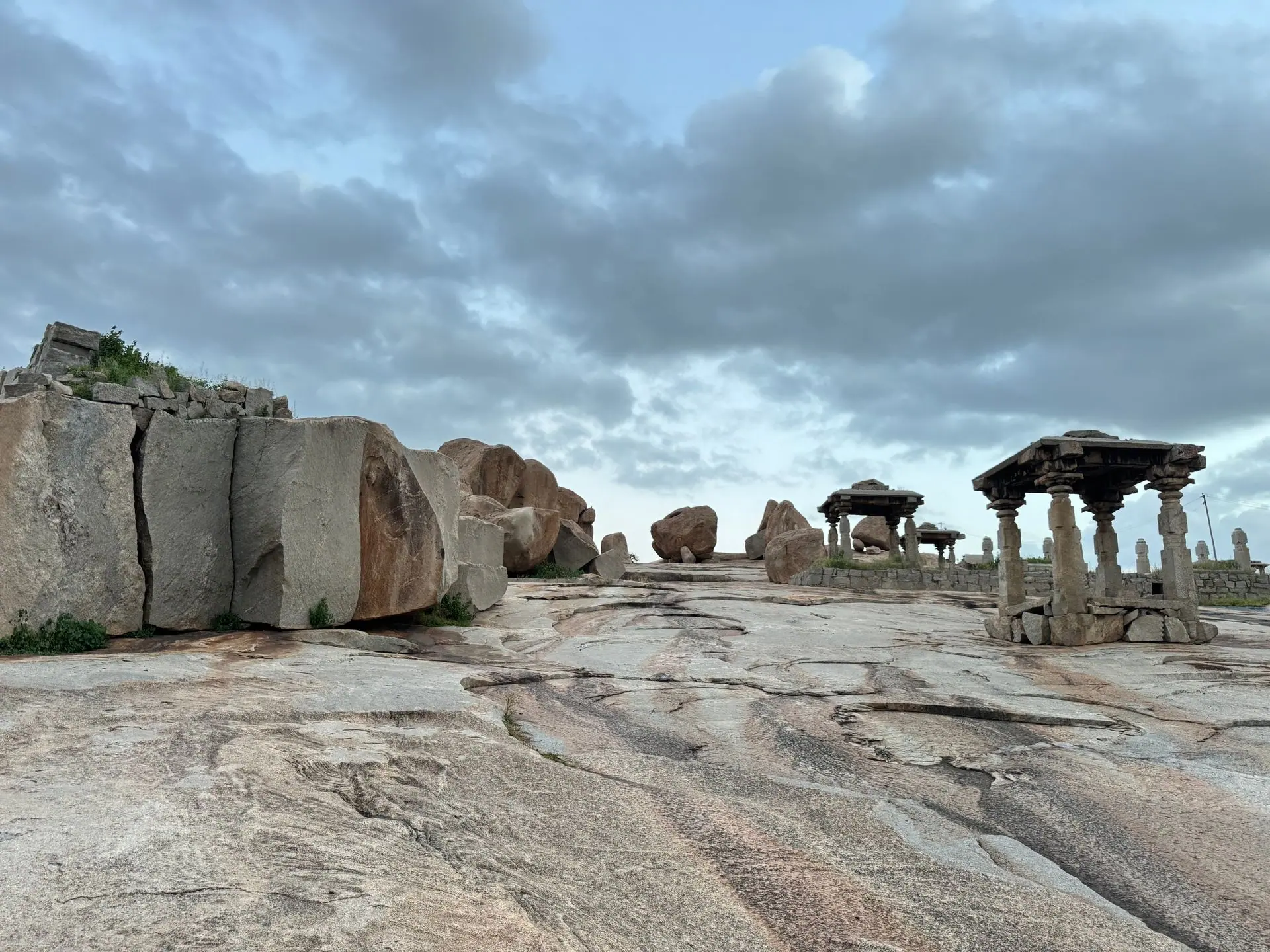 Dramatic cloudy sky over ancient stone ruins in Hampi, Karnataka, India