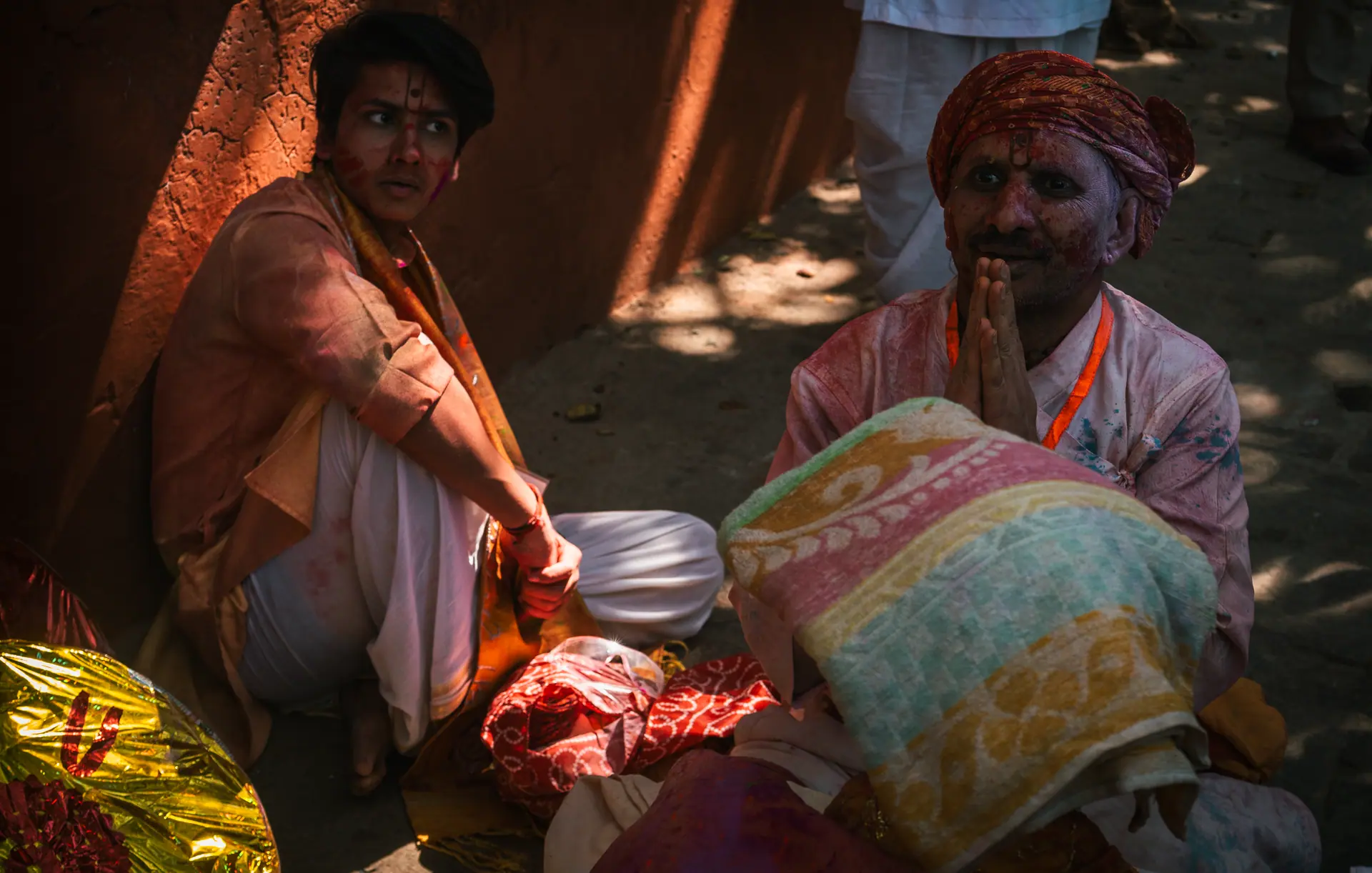 Participants in traditional attire celebrate Lathmar Holi in Barsana, India, a vibrant Hindu festival