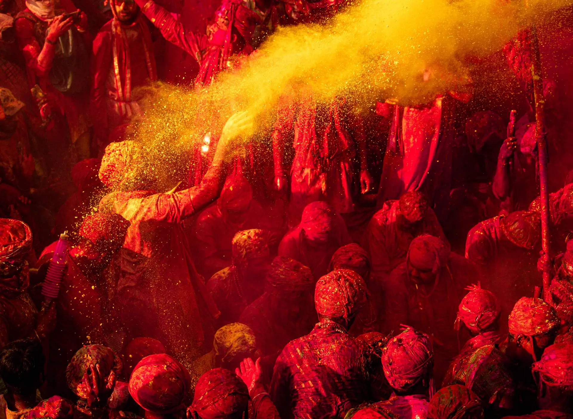 Colorful Holi celebration with people enjoying vibrant powder in Vrindavan, India