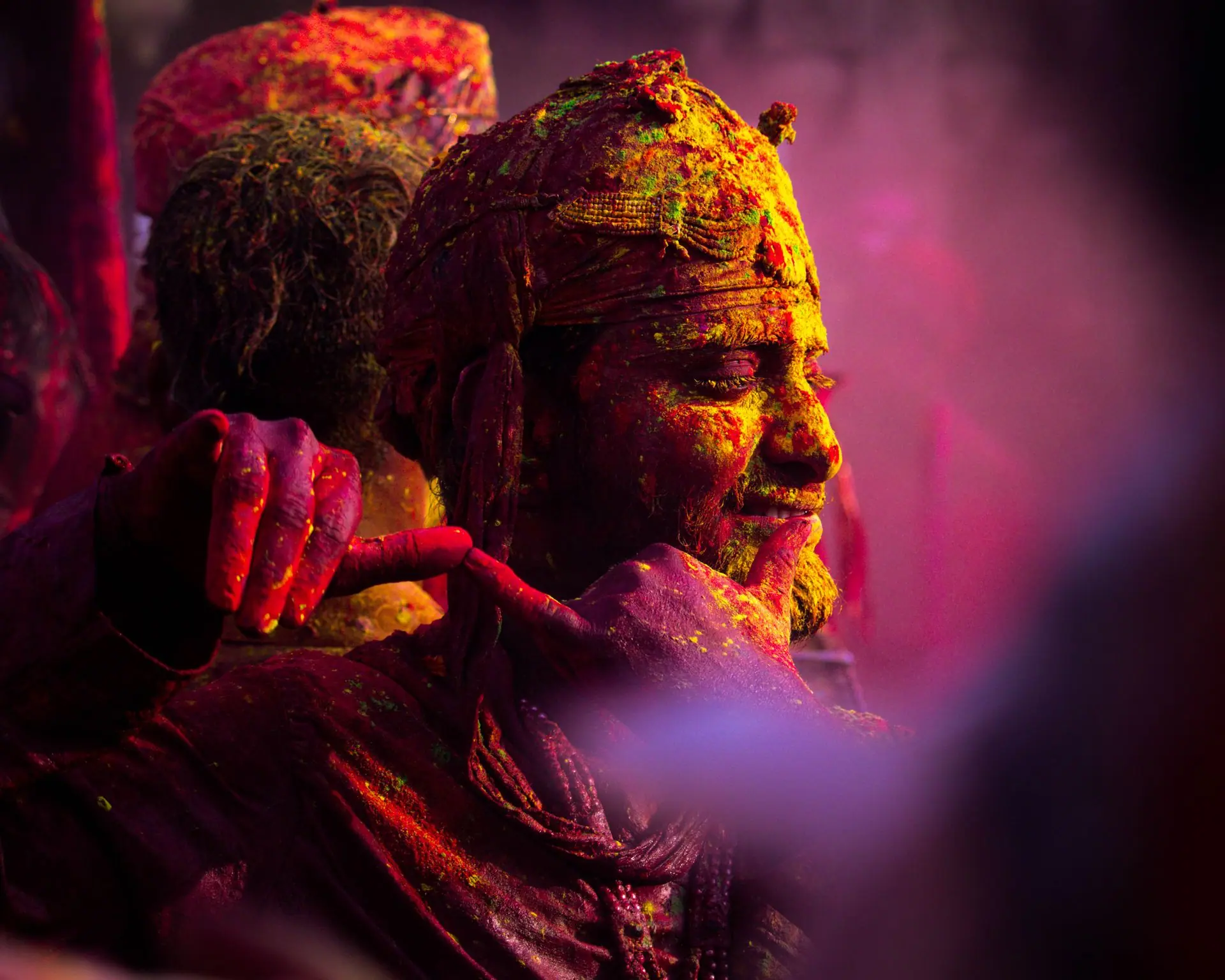 Colorful Holi celebration in Vrindavan with people covered in vibrant powder