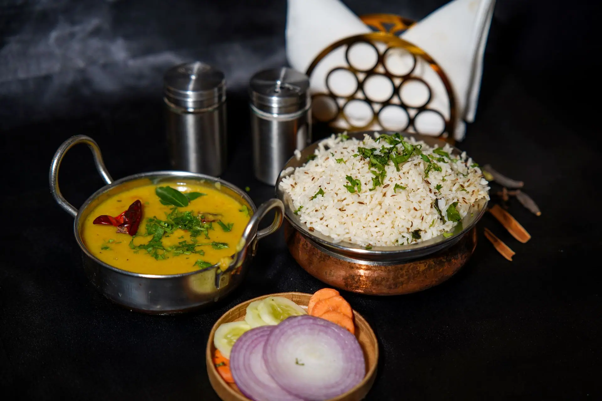 A tantalizing display of Indian rice and dal tadka with spices, perfect for food lovers