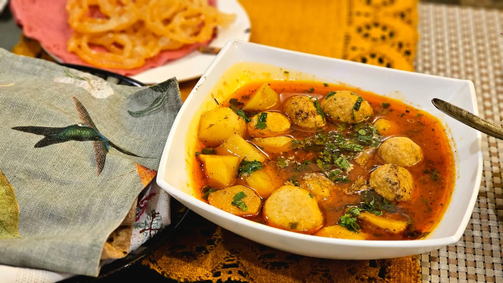 Delicious bowl of Indian potato and kofta curry with vibrant flavors and spices