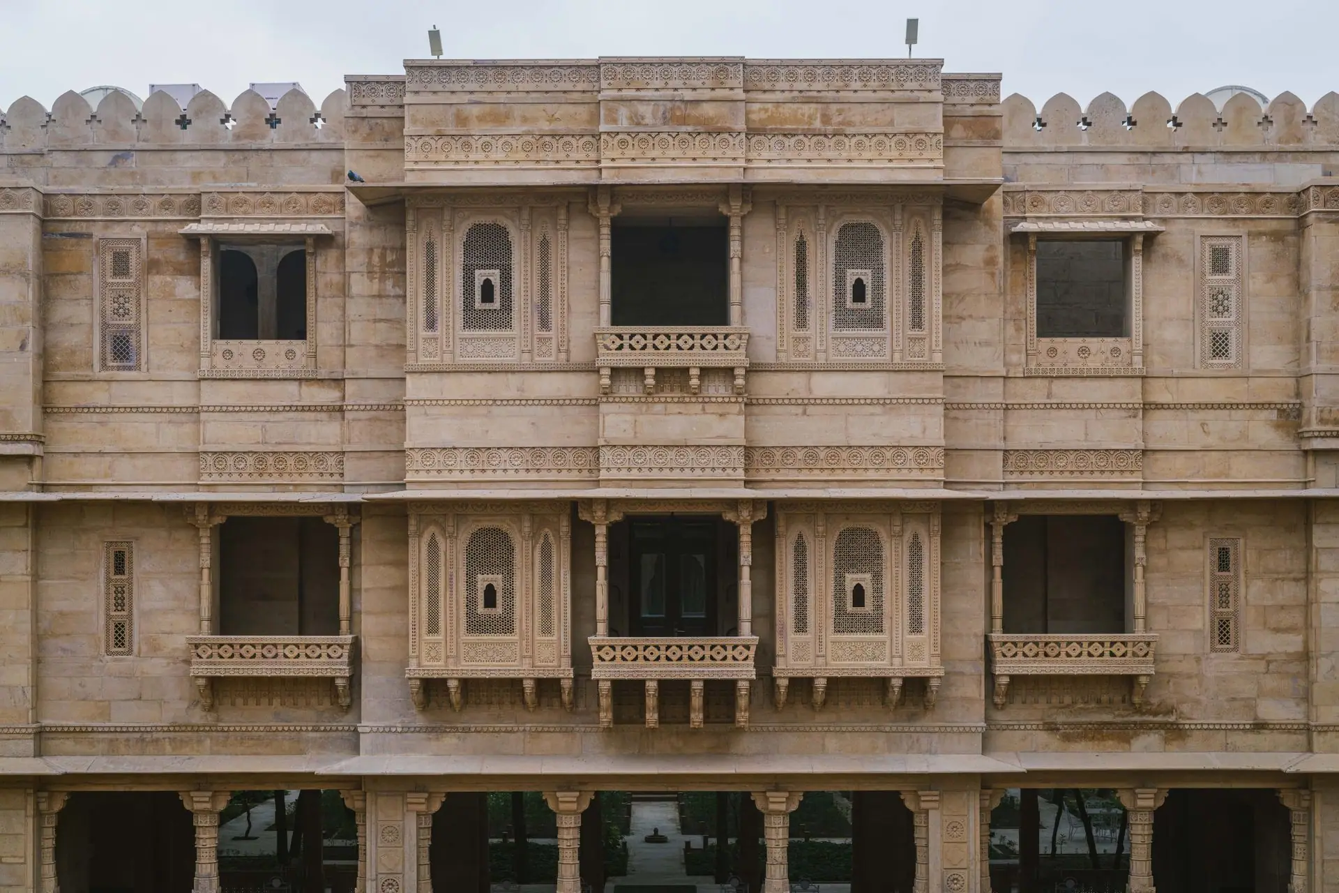 Impressive stone facade of a palace hotel in Jaisalmer, showcasing intricate architectural details