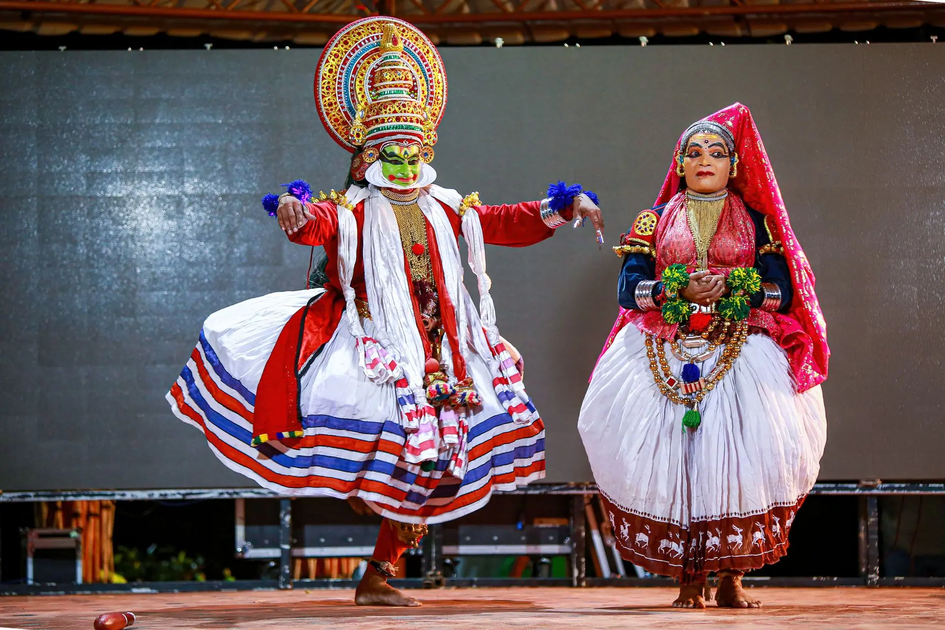 Vibrant display of Kathakali dancers in traditional costumes on stage in Thiruvananthapuram