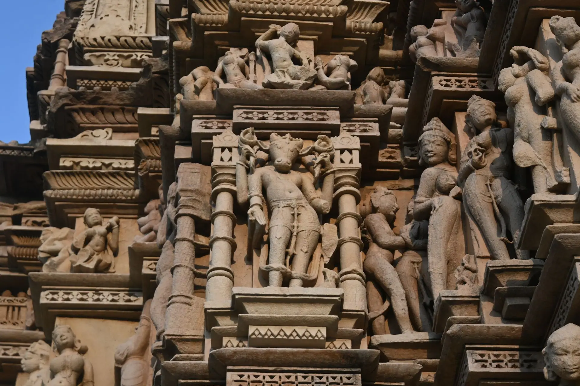 Detailed carvings on a historic Khajuraho temple, showcasing ancient Indian art and architecture