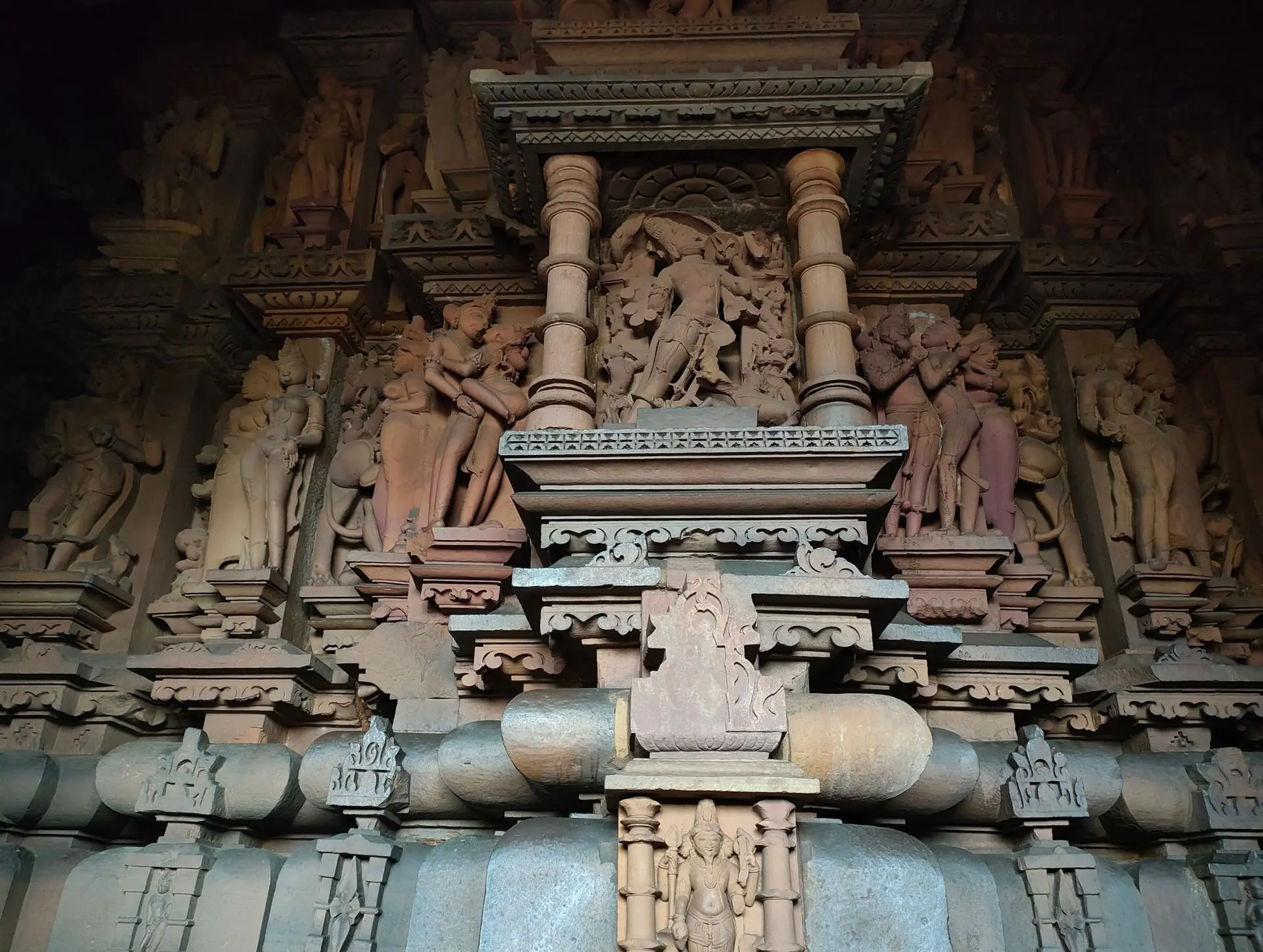 Detailed stone carvings from a temple in Khajuraho, showcasing ancient Indian art and architecture