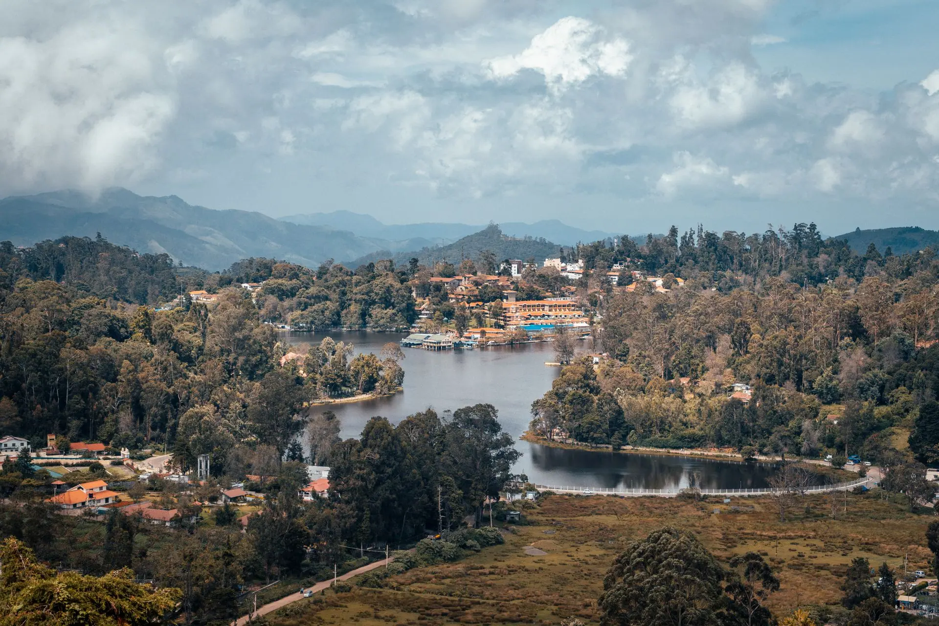 A beautiful aerial shot of Kodaikanal's lush landscape and serene lake surrounded by mountains