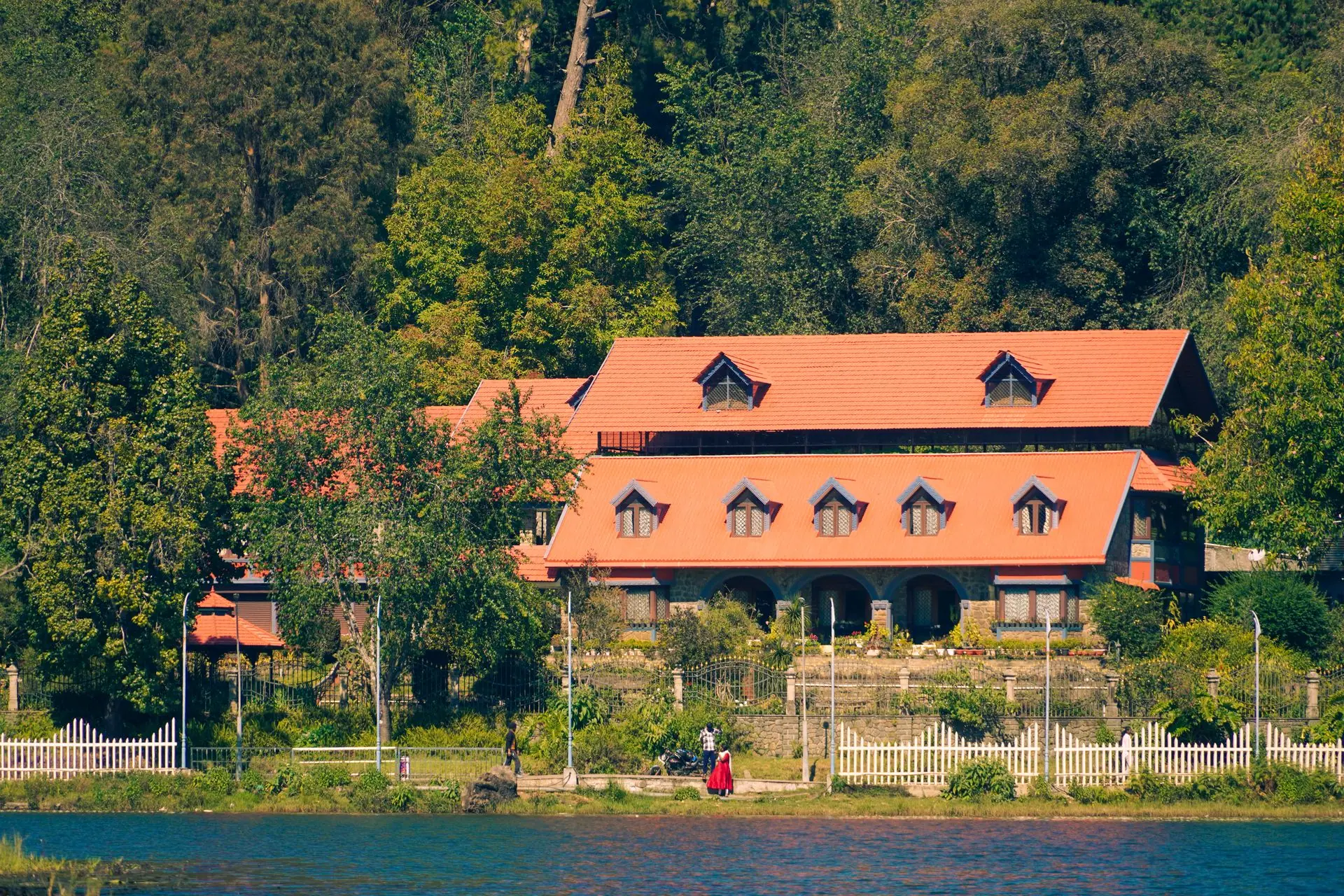 A picturesque house with red roof by the lakeside in Kodaikanal, India