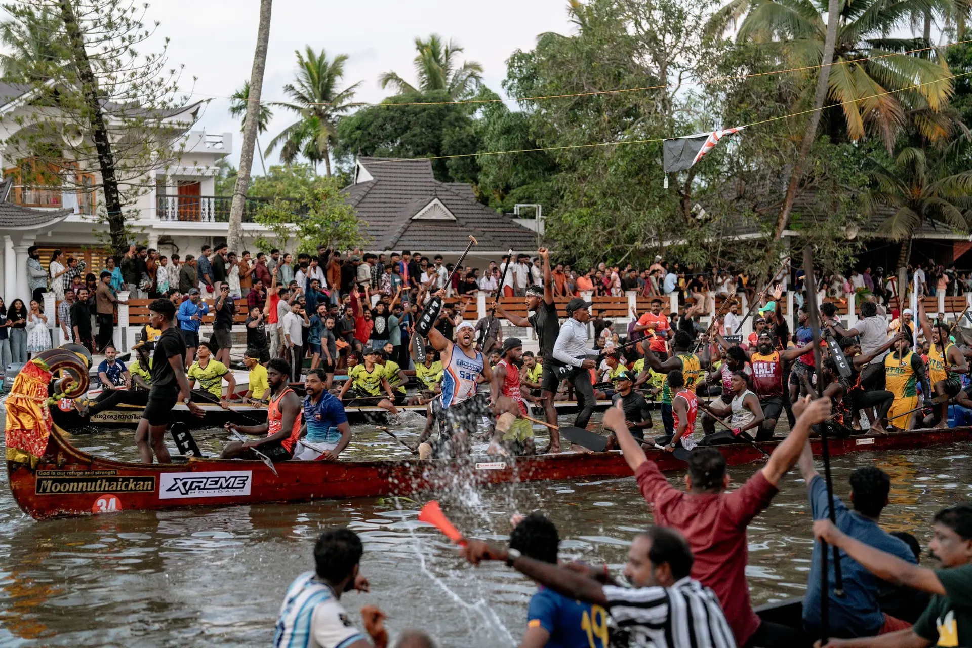 Exciting boat race with colorful teams and cheering crowds in Kumarakom, Kerala, India