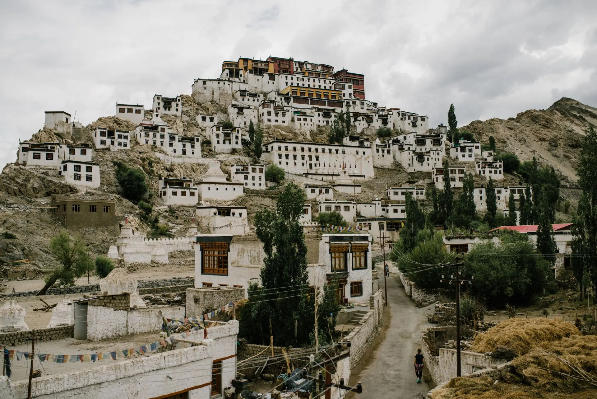 Scenic view of Thiksey Monastery nestled in the mountains of Ladakh, India with overcast skies