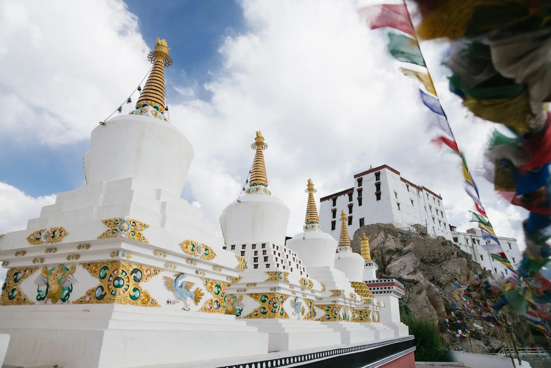 Beautiful view of Thiksey Monastery with white stupas under a bright sky in Ladakh, India