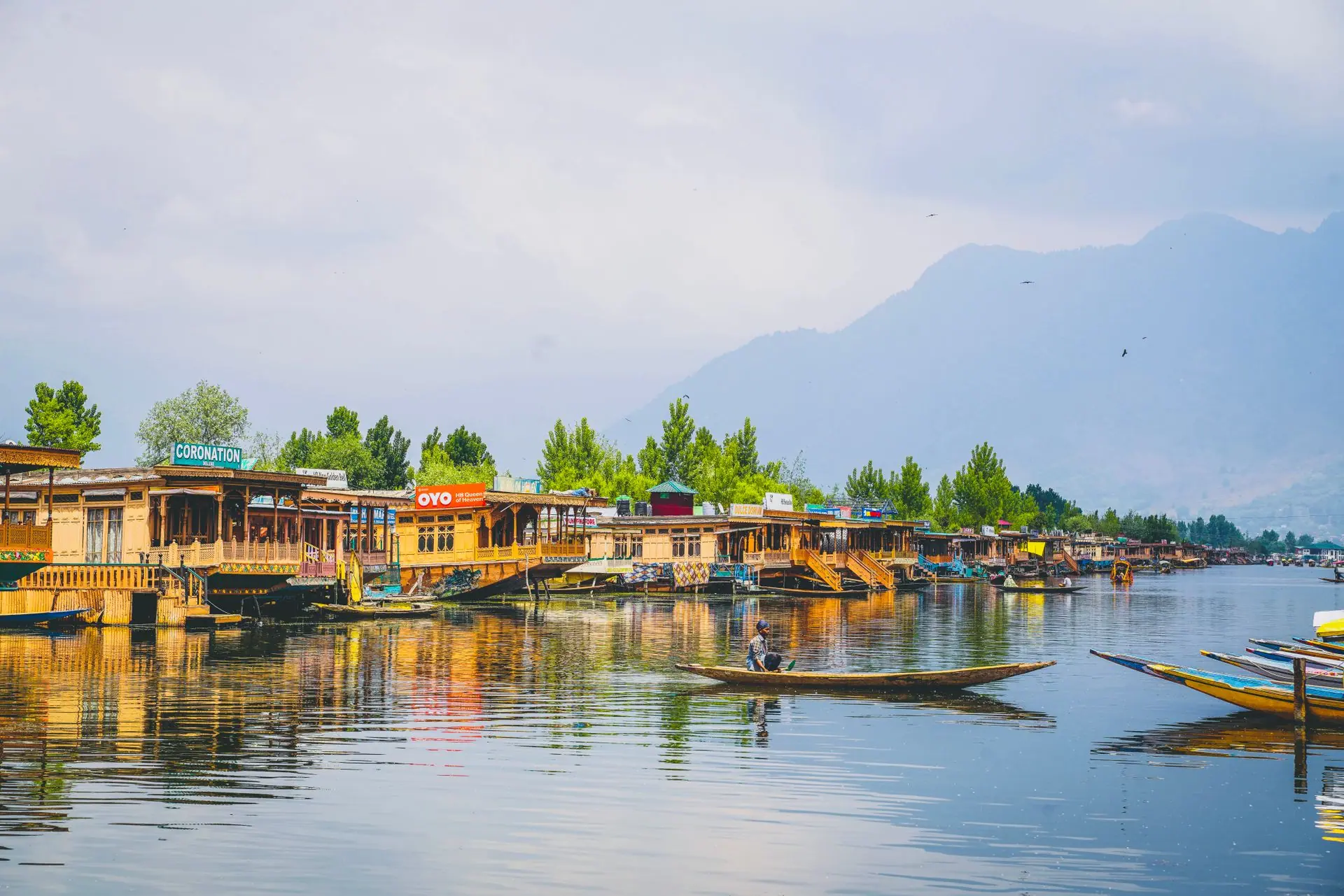 Scenic view of traditional houseboats and shikara on Dal Lake, Srinagar, reflecting serene beauty