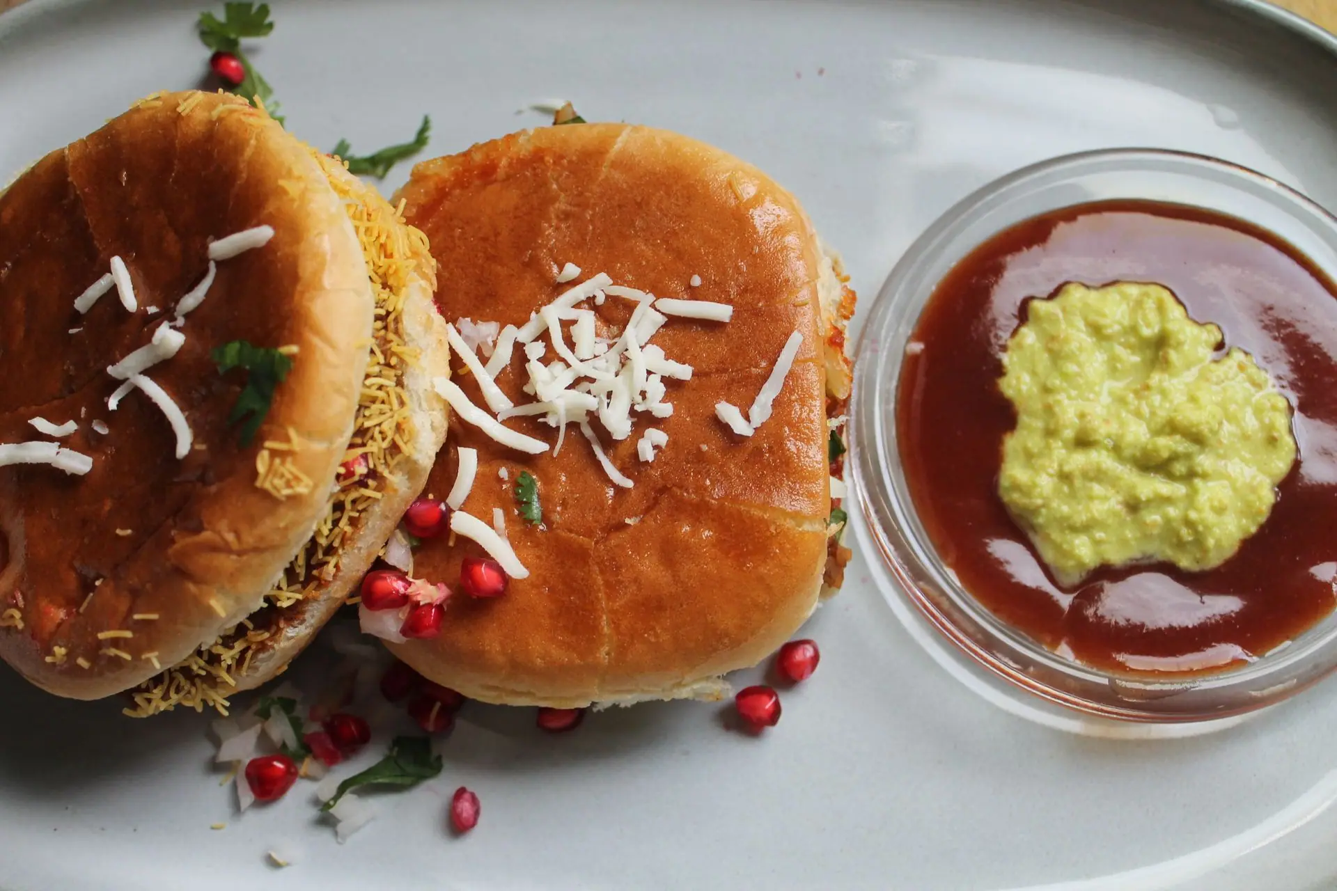 Top view of spicy Indian street food burgers served with flavorful chutney dips
