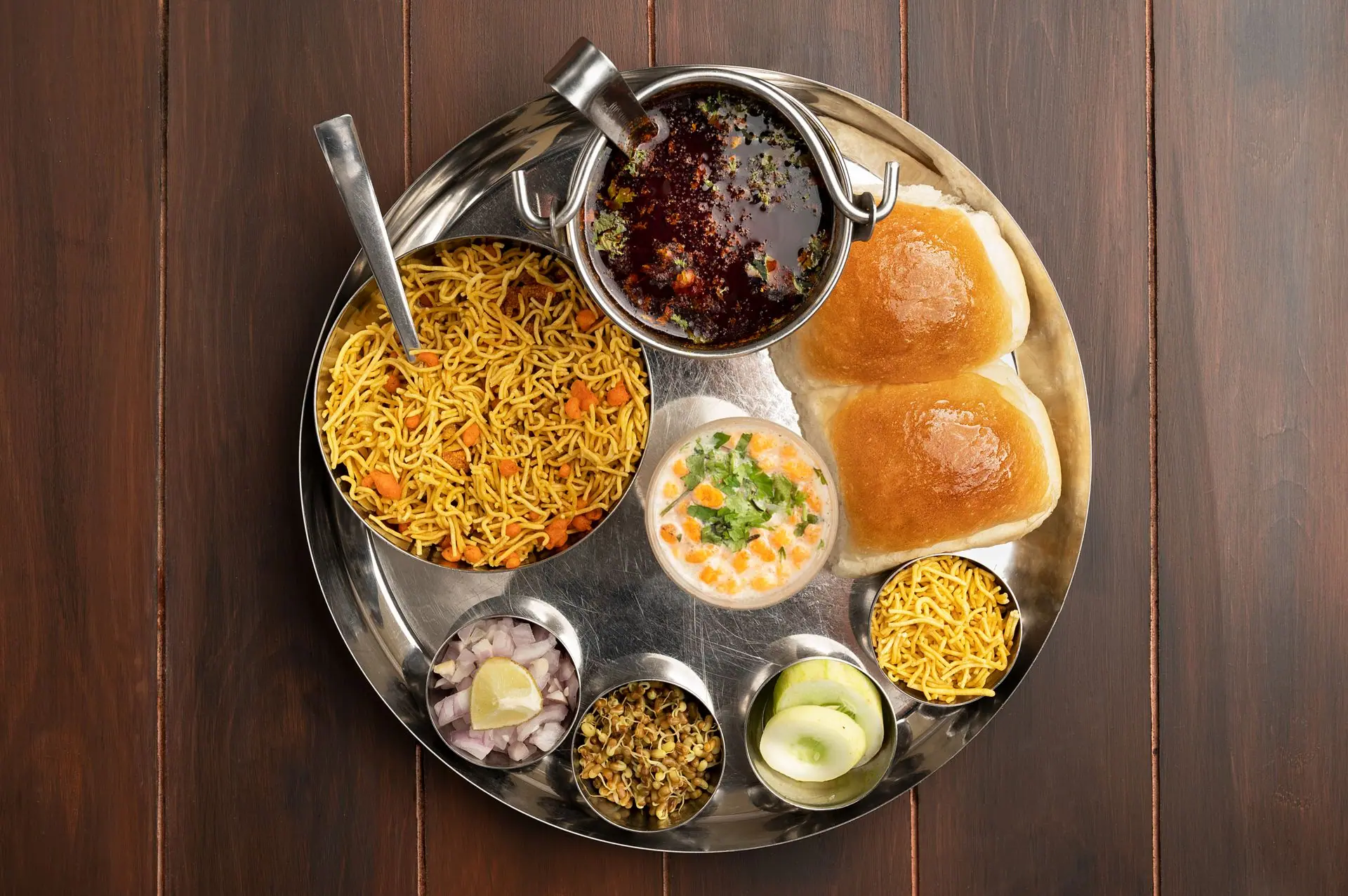 Delicious authentic Misal Pav meal on a traditional thali, showcasing Indian street food culture