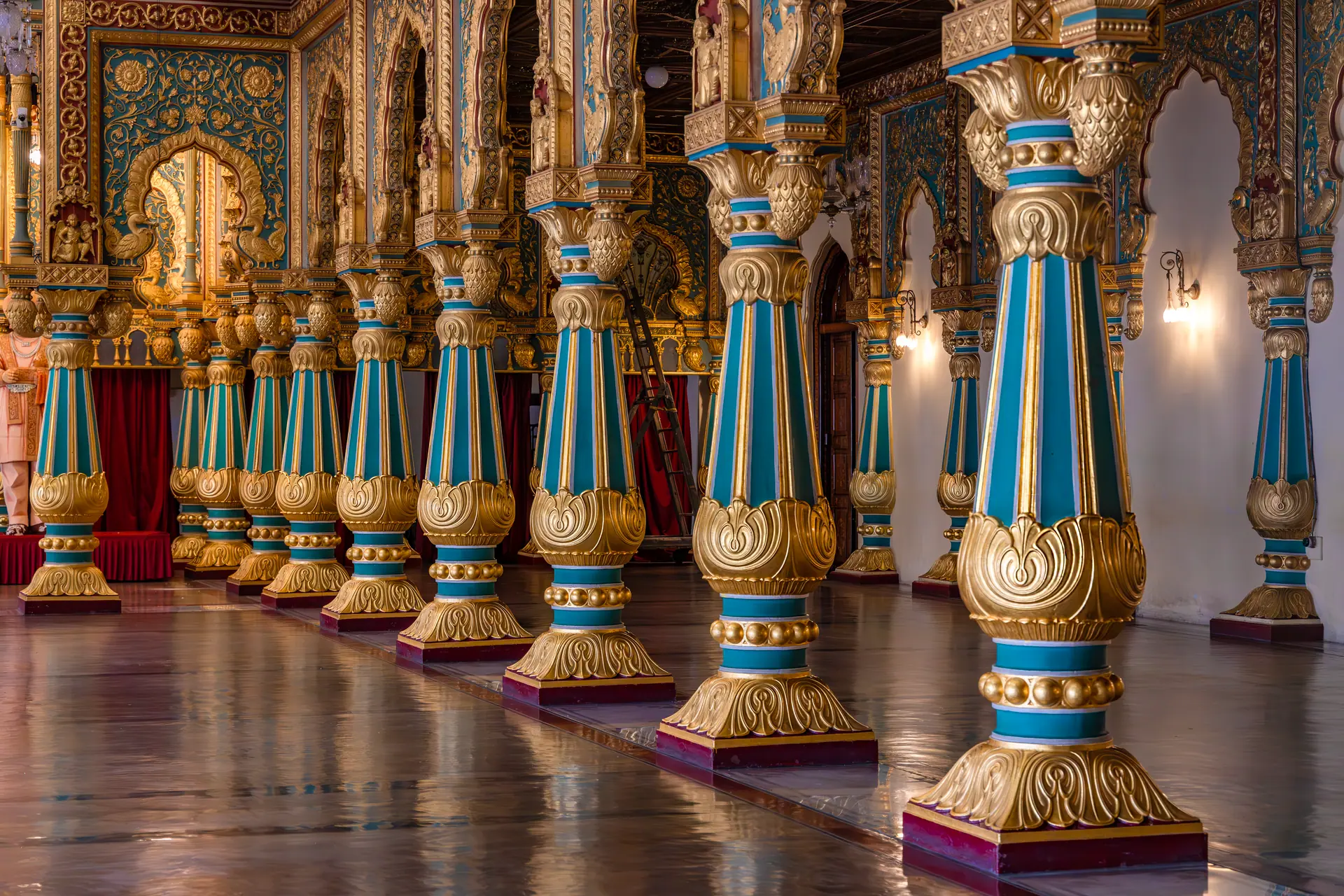 Explore the stunning intricacies of Mysore Palace's opulent interior, featuring lavishly decorated columns
