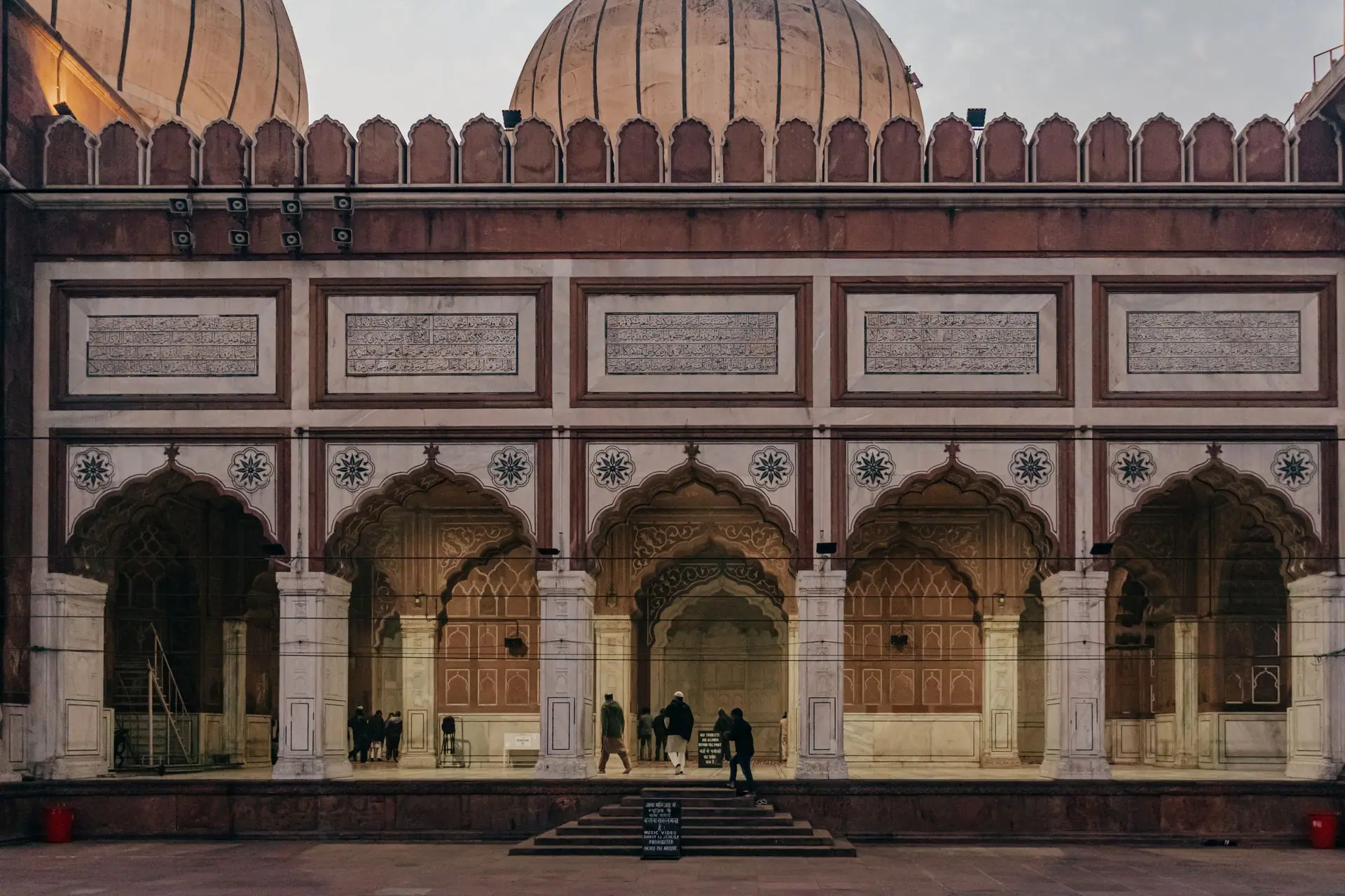 Intricate arches and domes of Jama Masjid, a landmark mosque in Delhi, India, showcasing traditional Islamic architecture