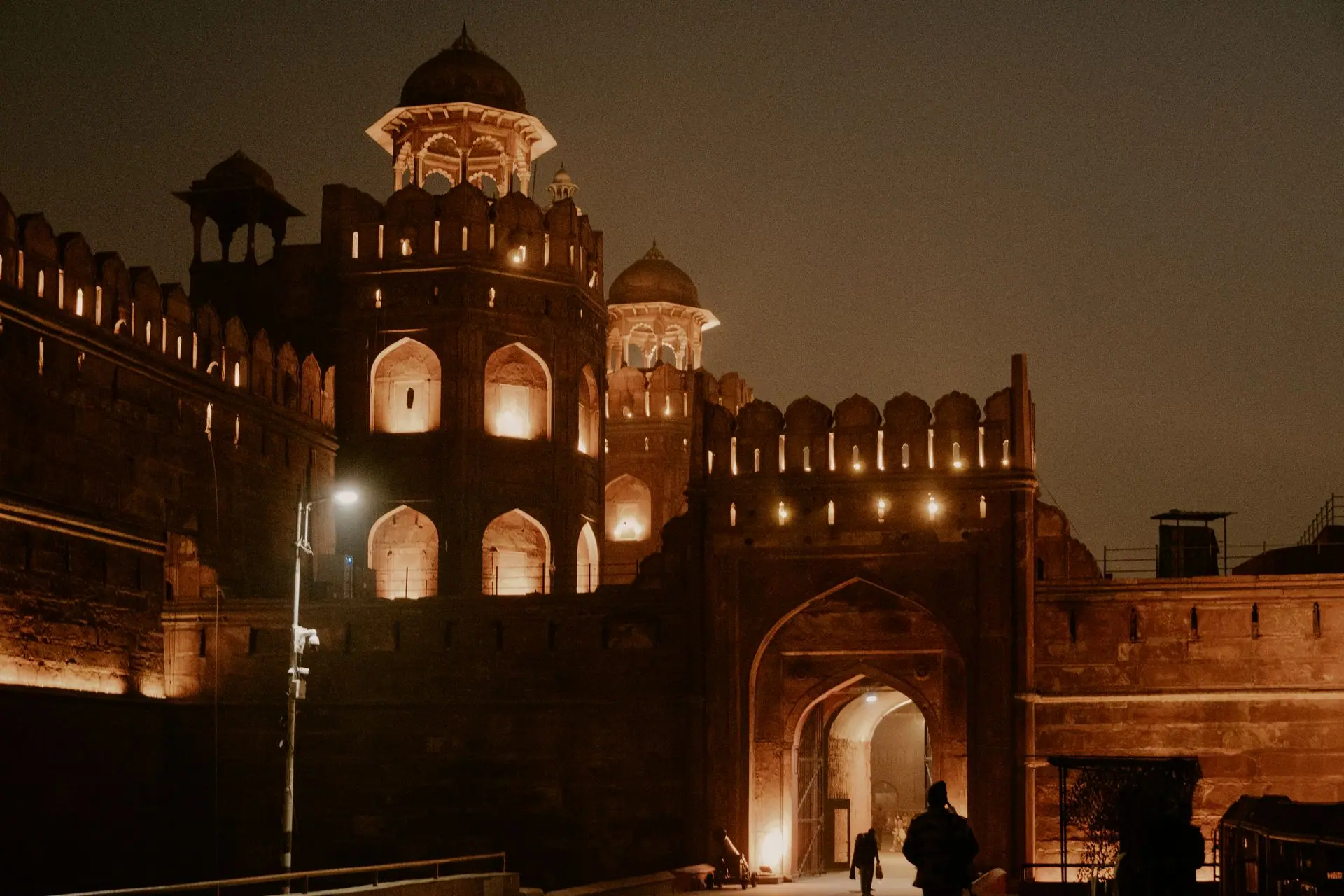 The Red Fort in New Delhi illuminated at night, showcasing its historic architectural beauty