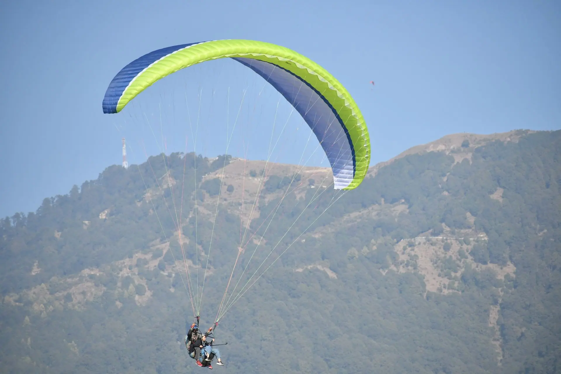 Thrilling paragliding over Bir's lush landscapes on a clear day