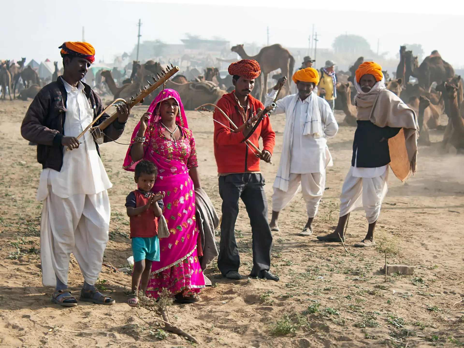 Indian musicians performing at a vibrant camel fair, showcasing Rajasthani culture