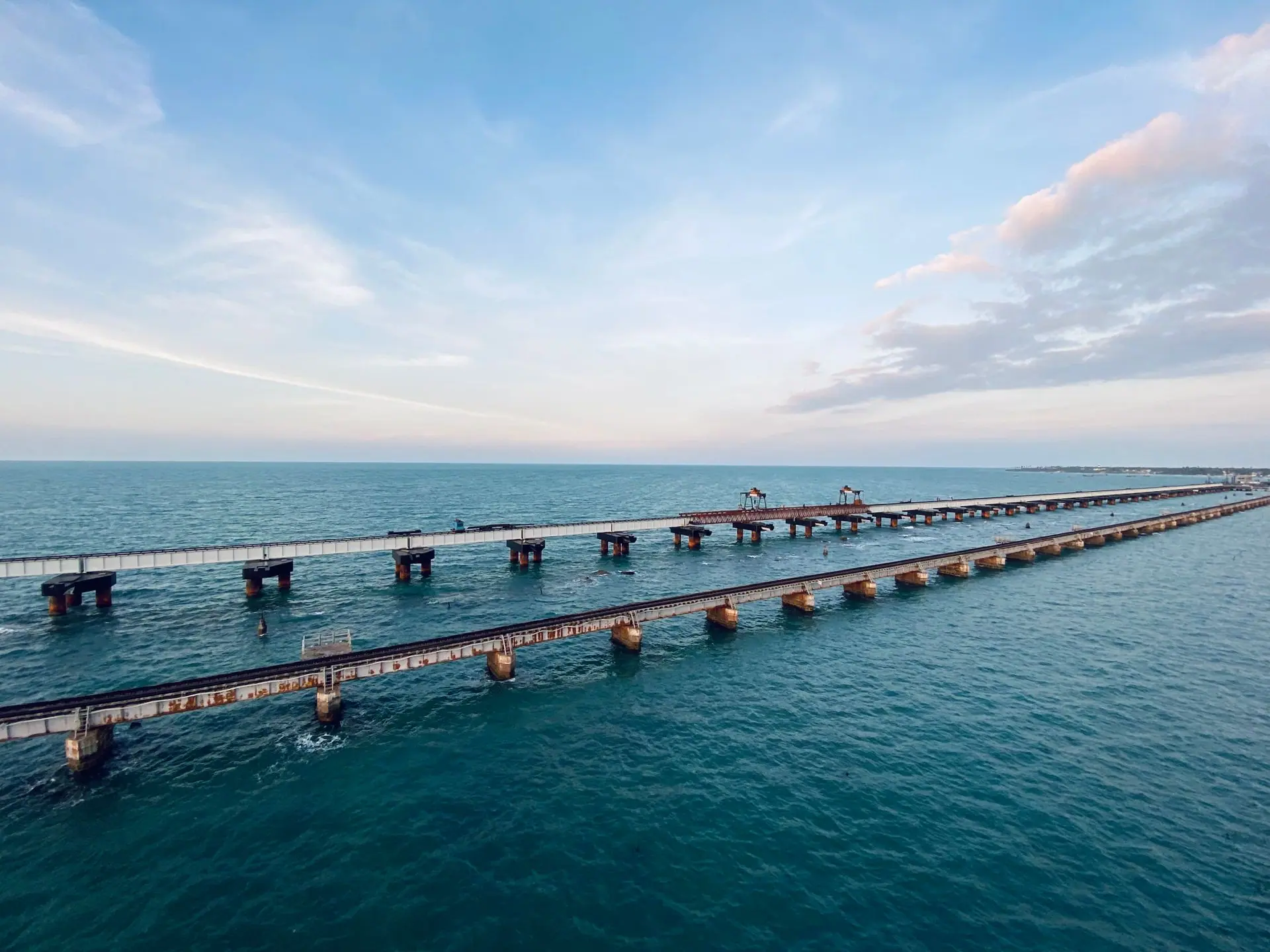 Aerial shot of the iconic Pamban Bridge over the blue waters of Rameswaram, India
