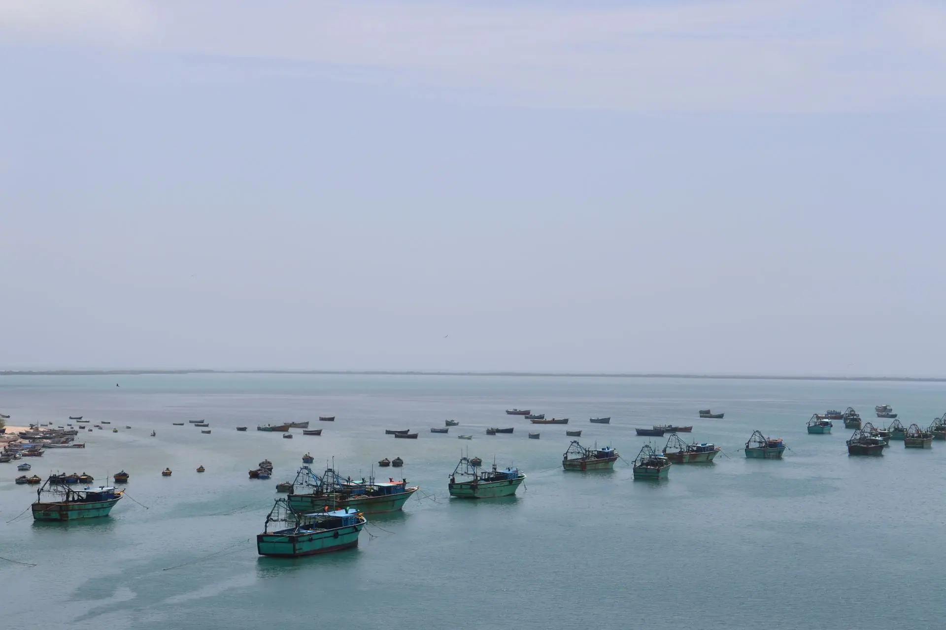 Serene aerial view of fishing boats in Rameswaram's clear blue waters