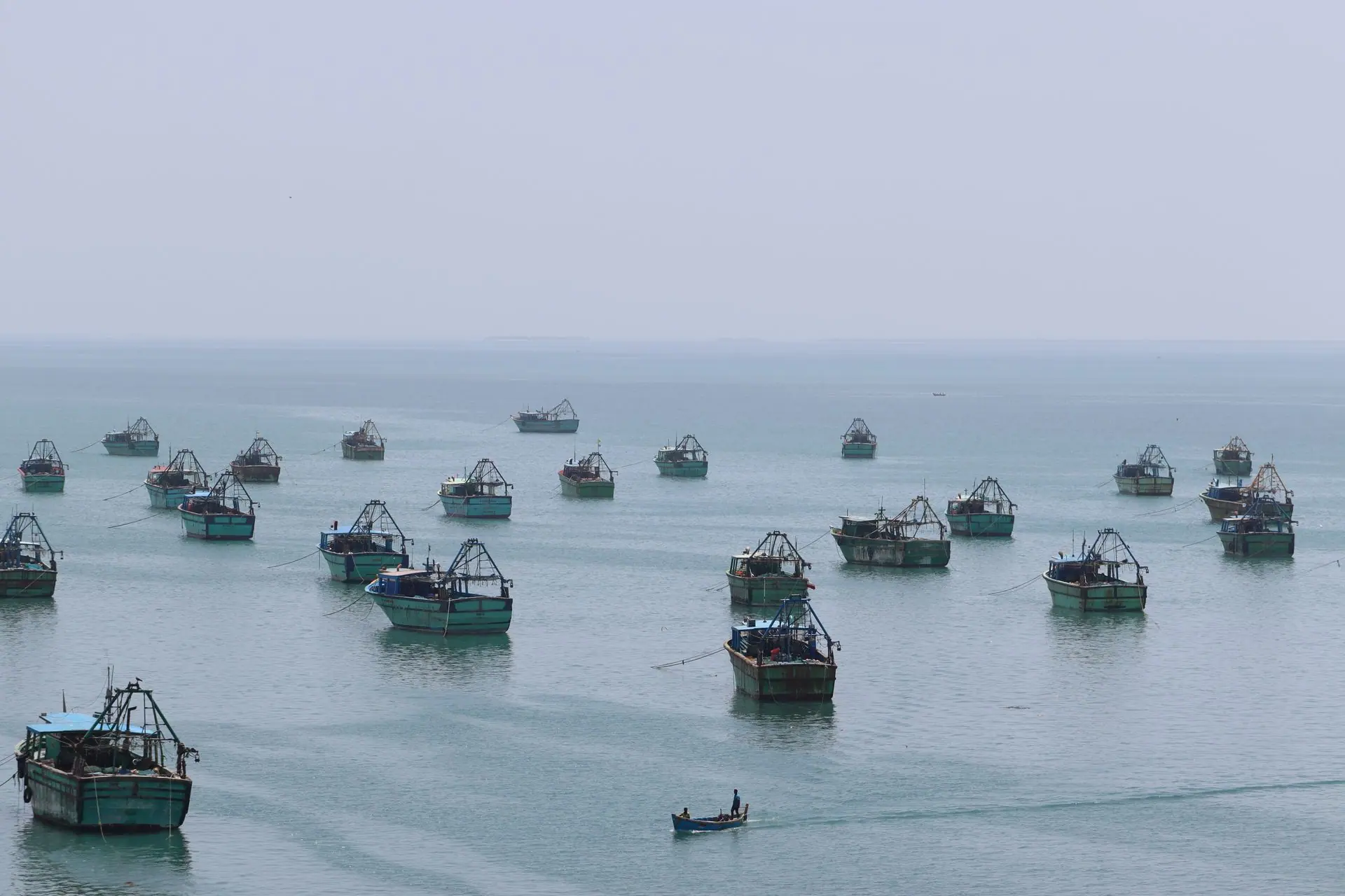 An array of fishing boats anchored on the serene waters off Rameswaram, India