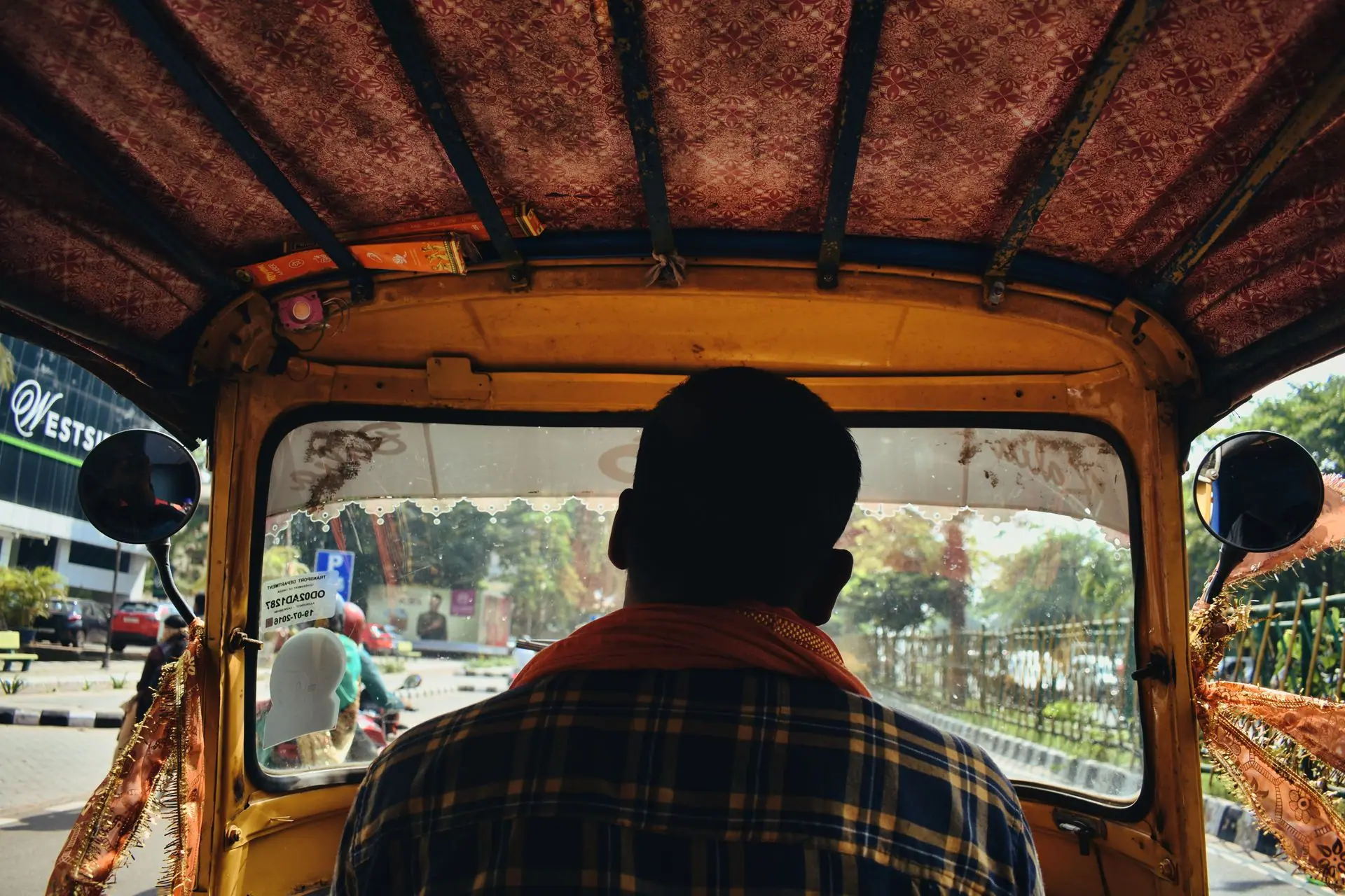 View from inside an auto rickshaw navigating city streets in Bhubaneswar, India