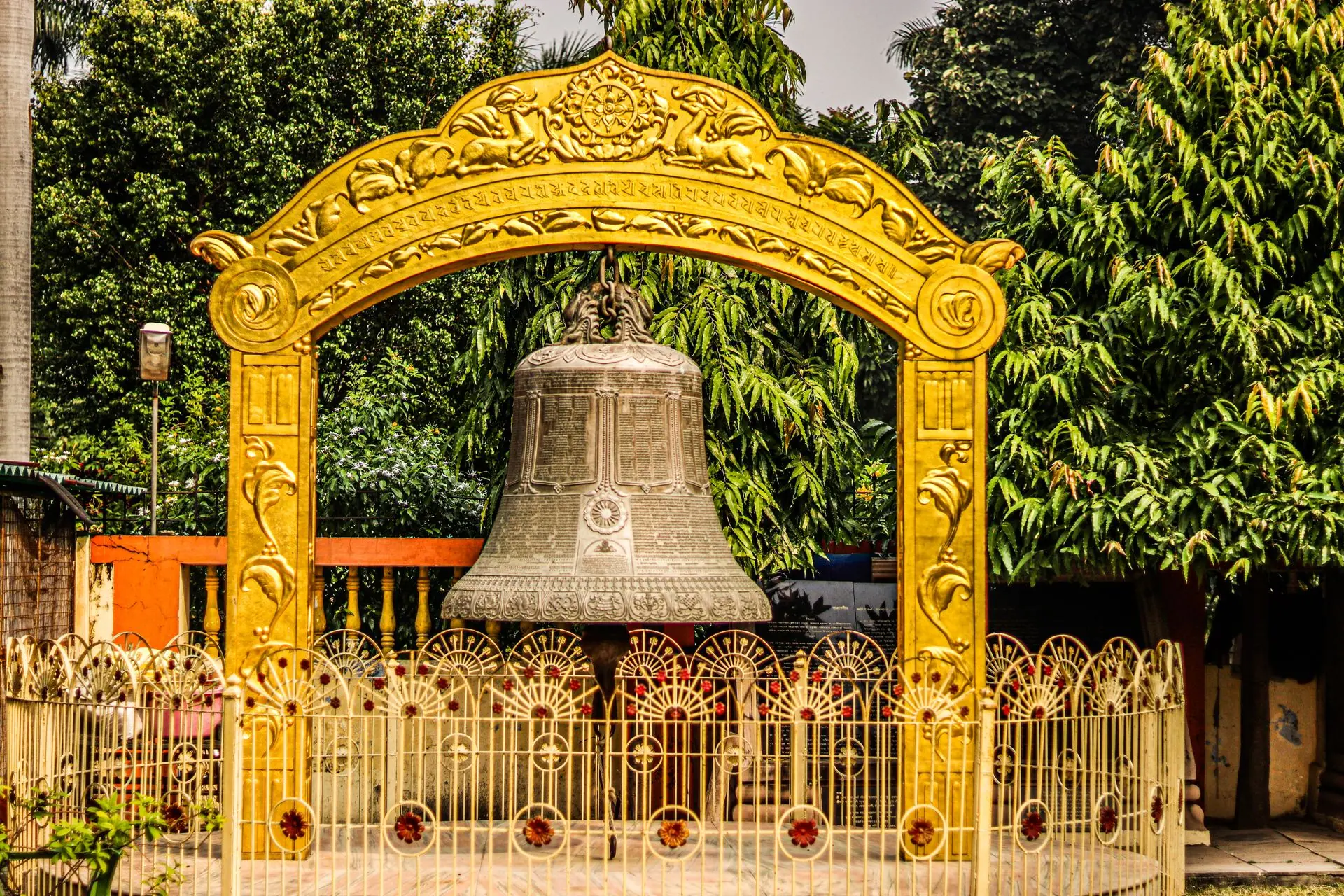 Giant engraved bell at Mulagandhakuti Vihara with ornate details in Sarnath, India